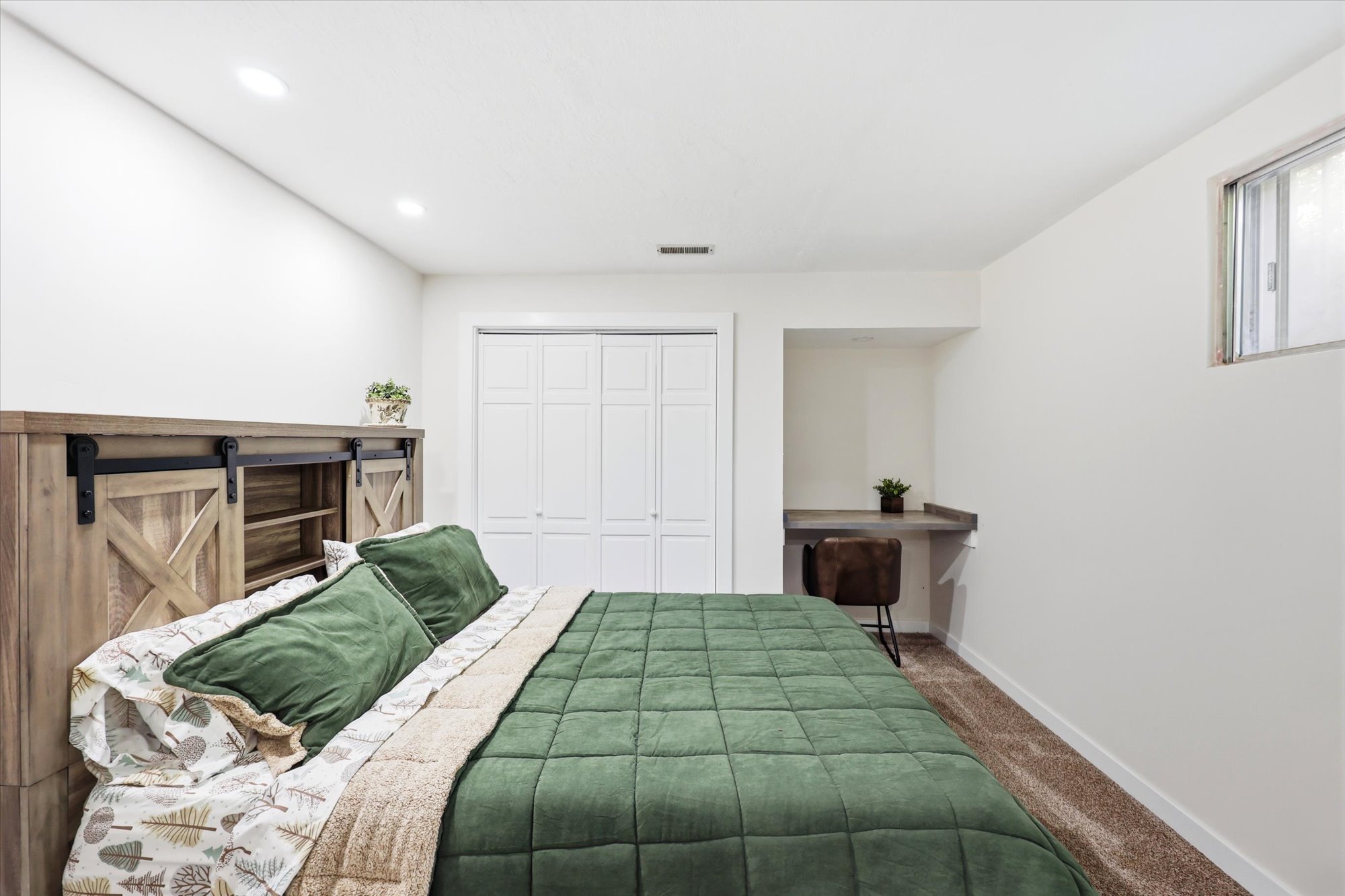 Bedroom featuring a built-in desk, recessed lighting, and carpet flooring