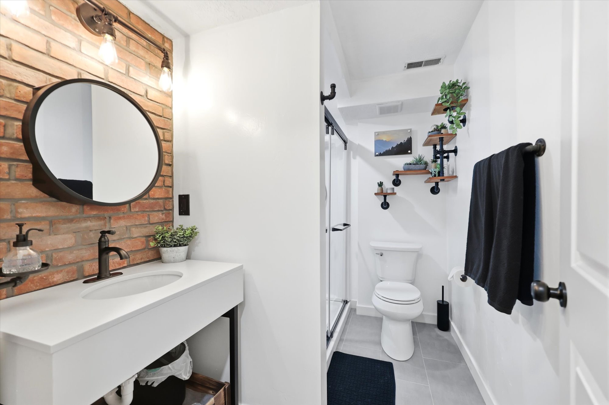 Bathroom featuring a floating vanity with a white countertop and integrated sink