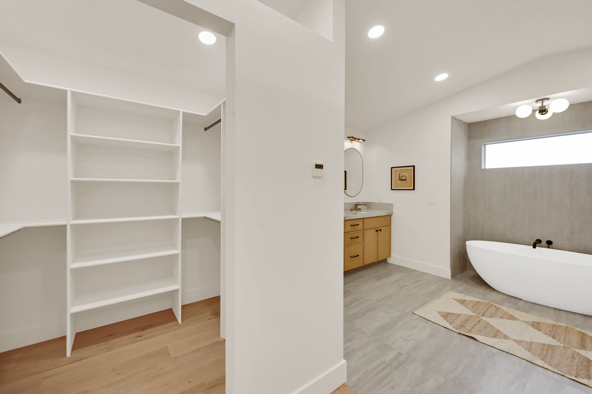 Primary bedroom featuring dual walk-in closets
