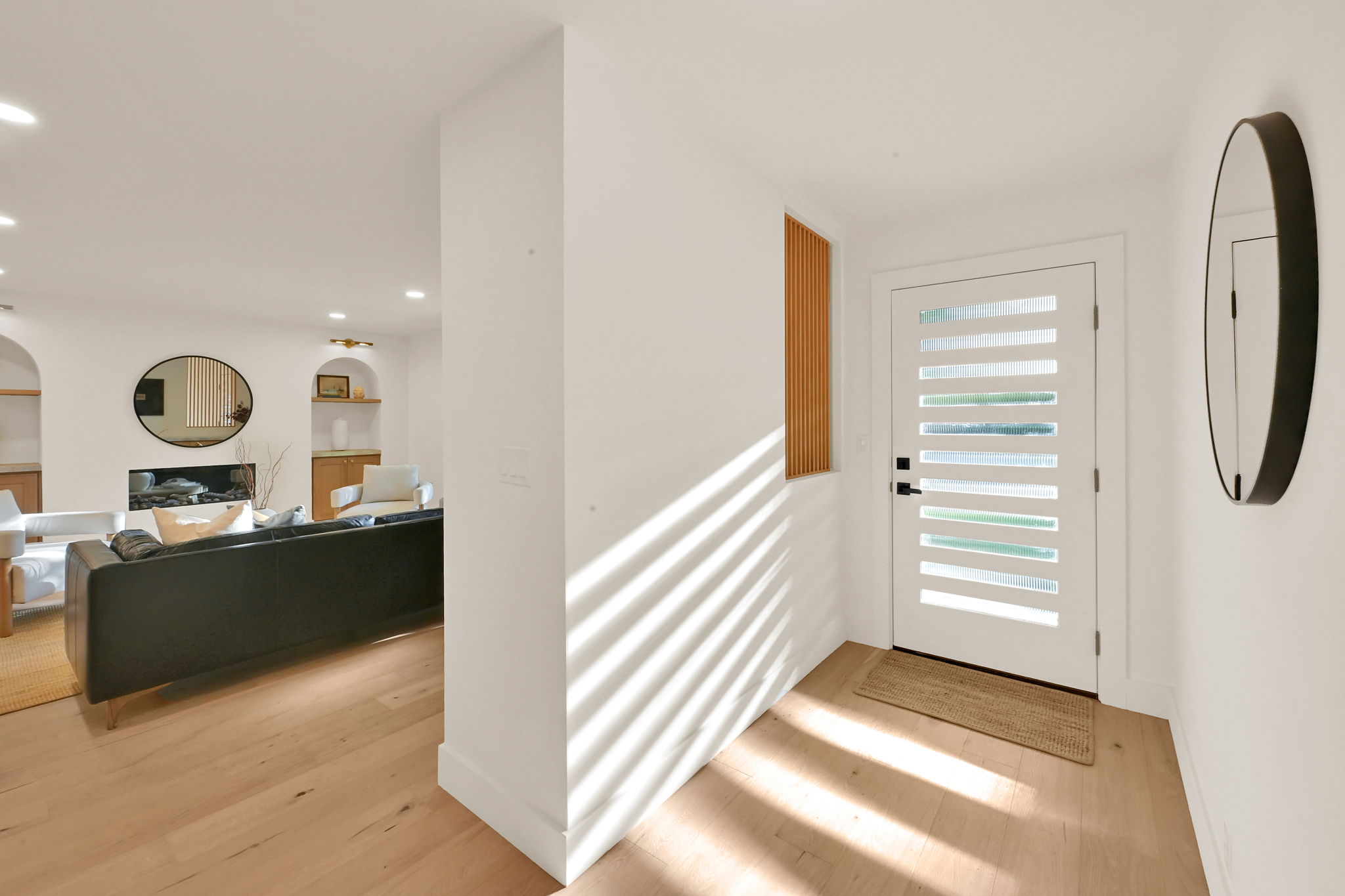 Entryway with a contemporary front door featuring horizontal opaque lites and a matte black handle