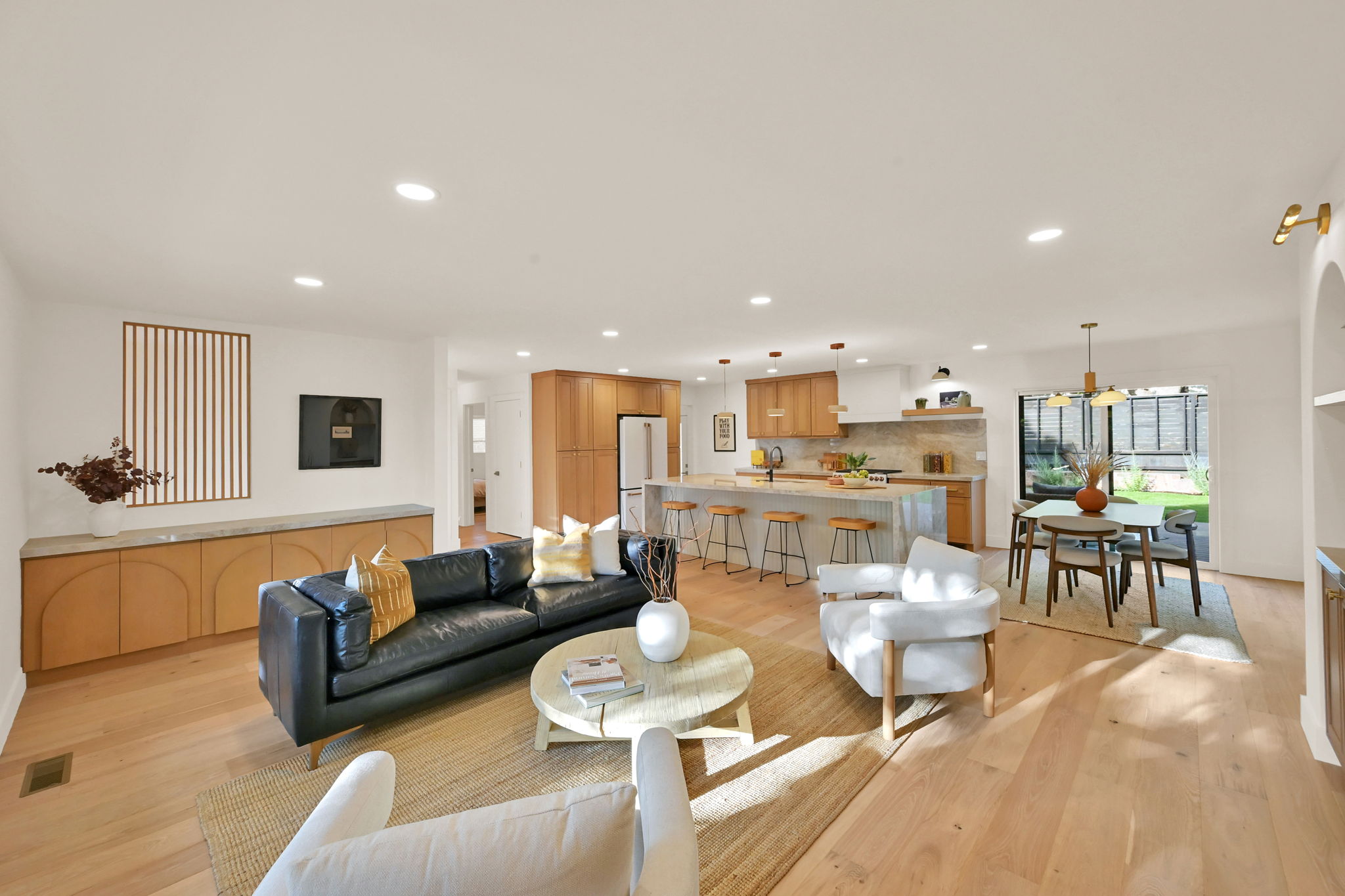 Open-concept living space with light wood flooring throughout