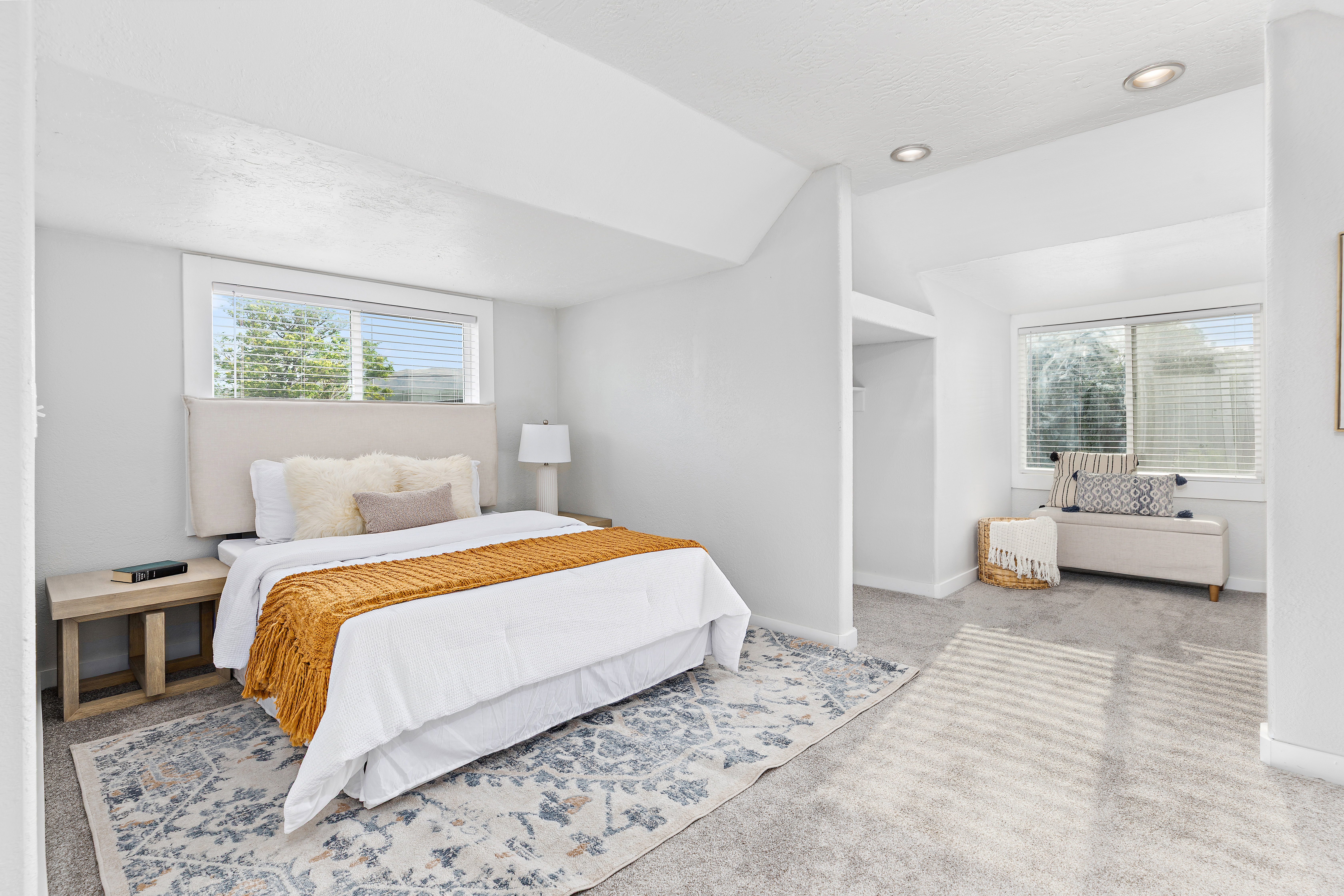 Light-filled interior space featuring recessed lighting and wall-to-wall carpeting