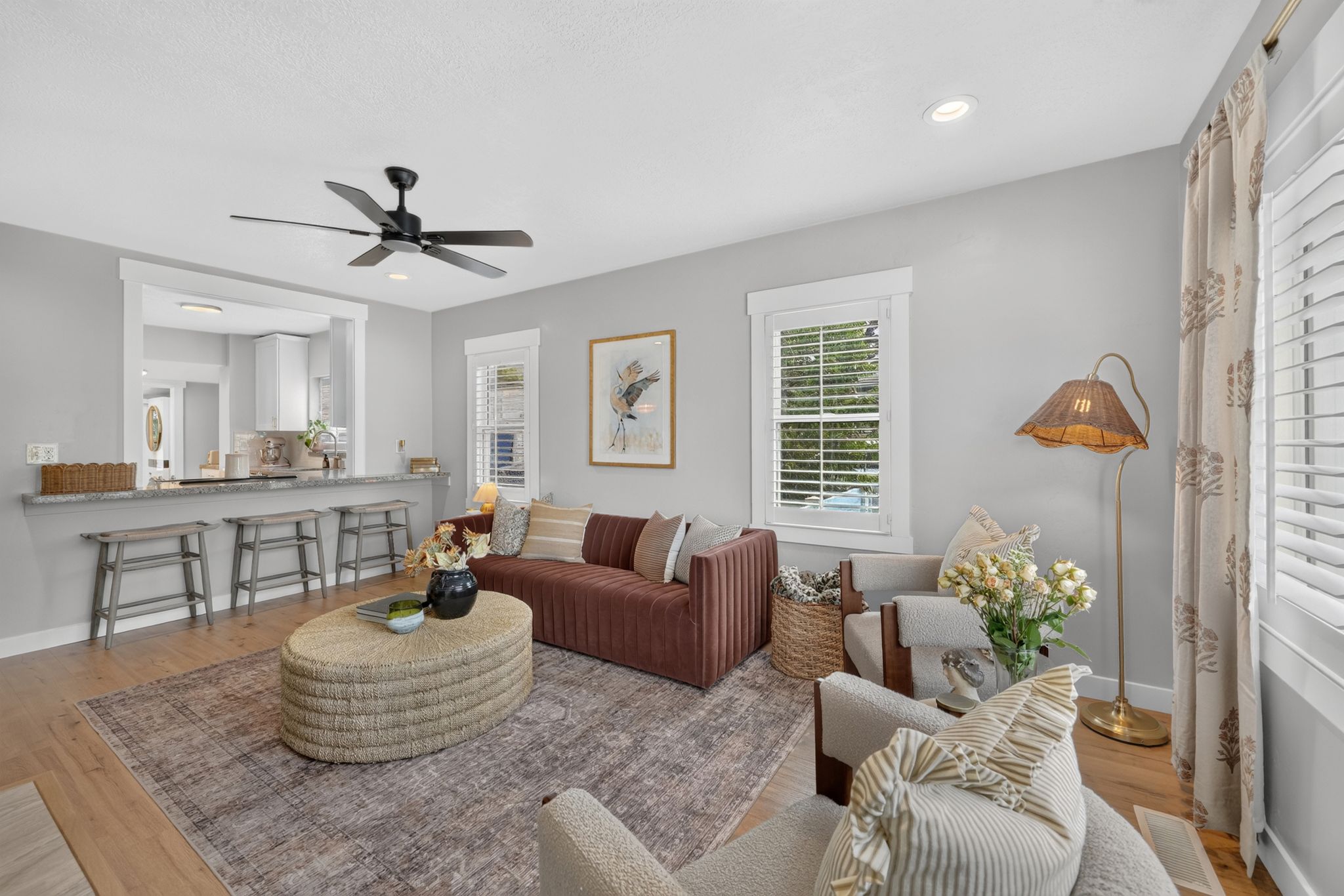 Living area featuring wood-finish flooring, recessed lighting, and a black ceiling fan