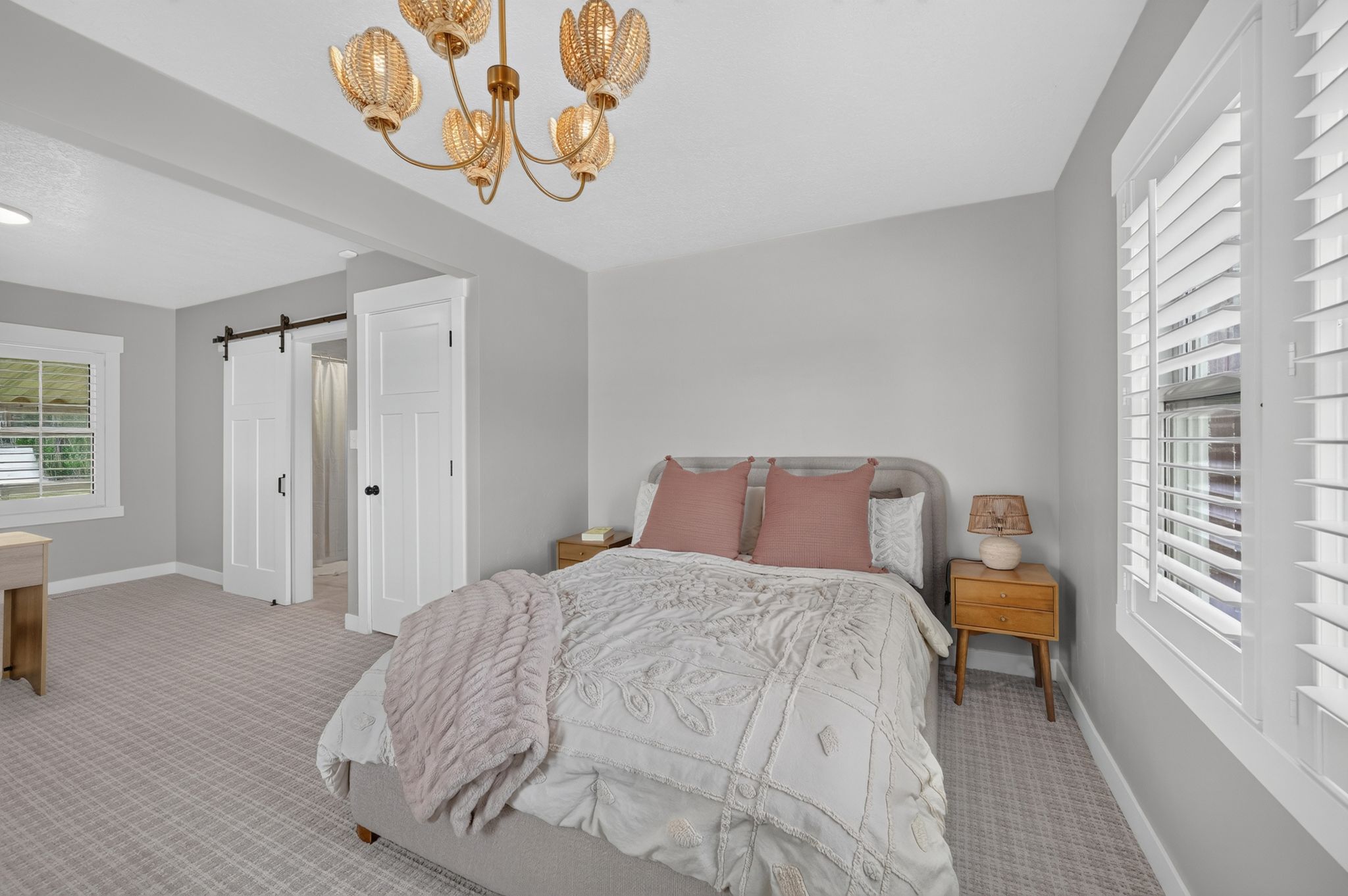 Room featuring patterned carpeting, white trim, and a decorative chandelier