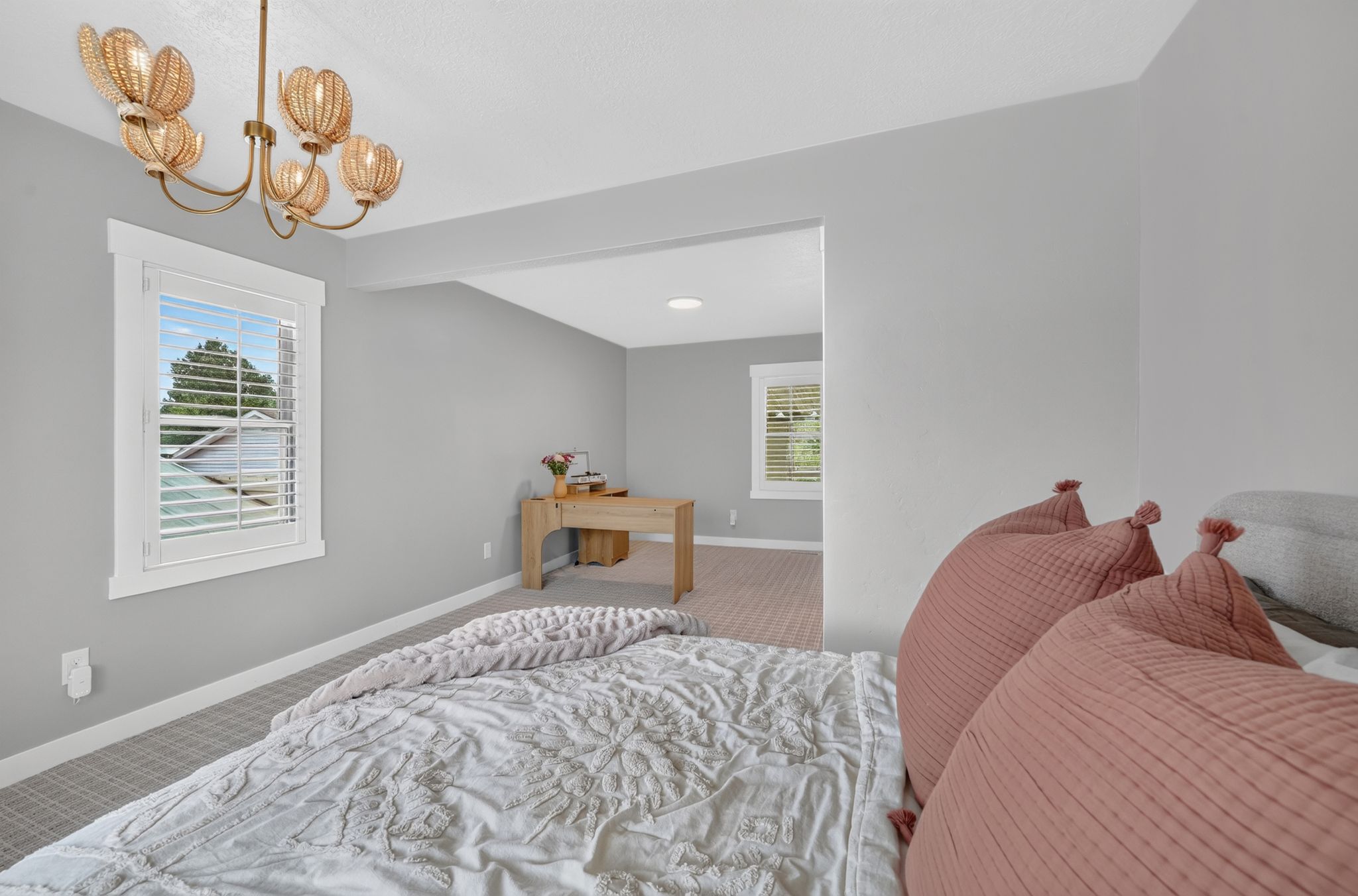 Recessed ceilings complement the decorative chandelier and light gray wall color
