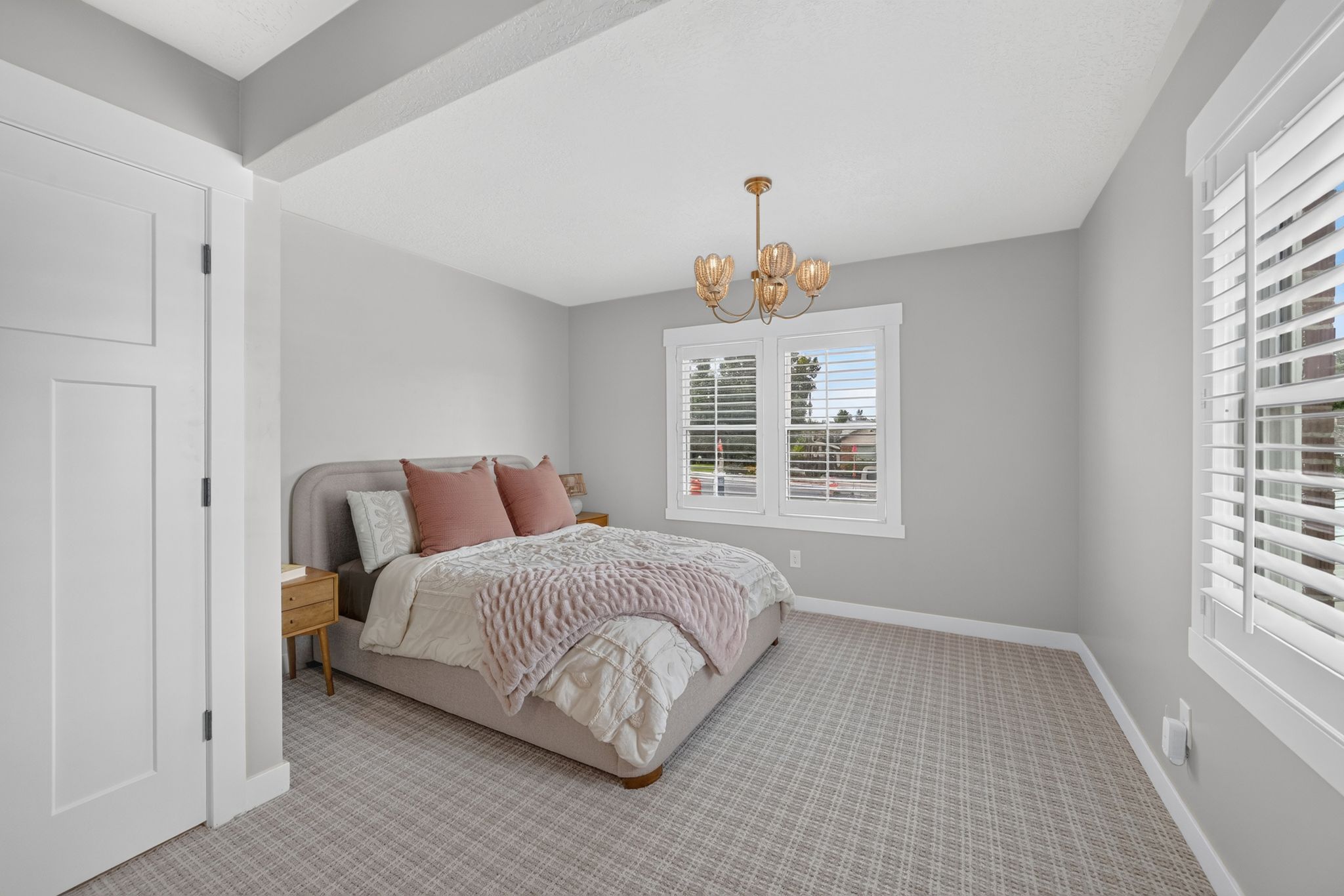 Room featuring light gray wall paint, patterned carpeting, and white trim