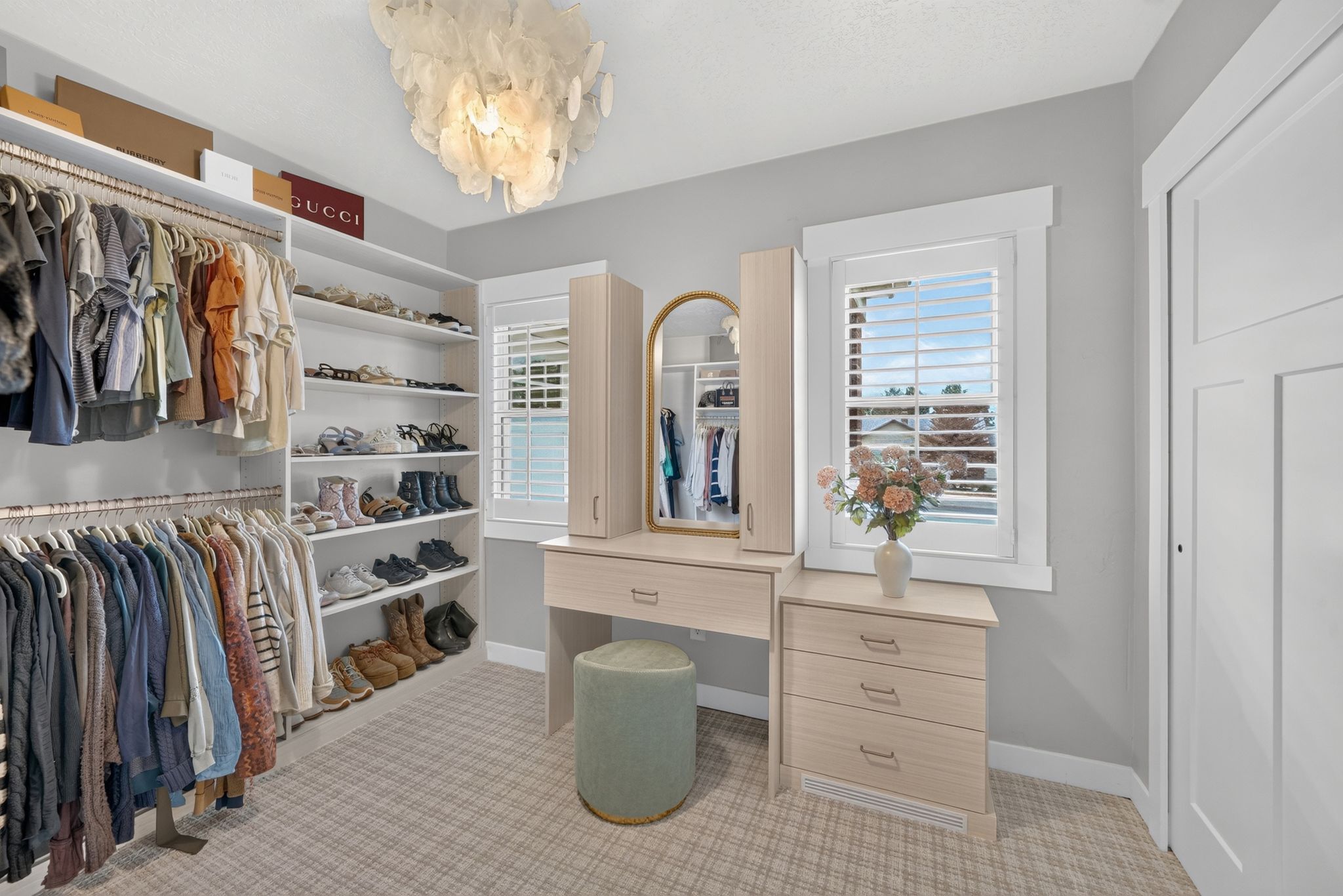 Custom closet system featuring extensive shelving and hanging rods