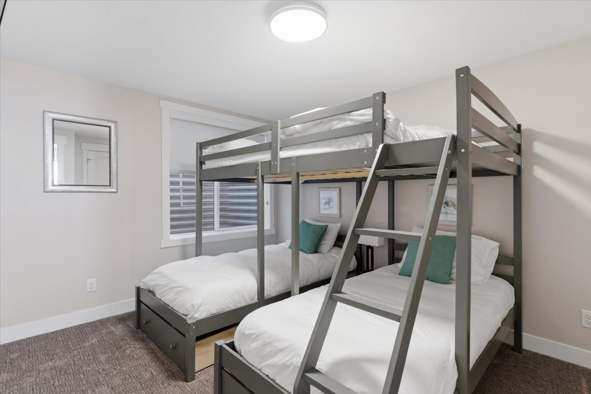 Neutral wall paint, plush carpet flooring, recessed window, and white trim