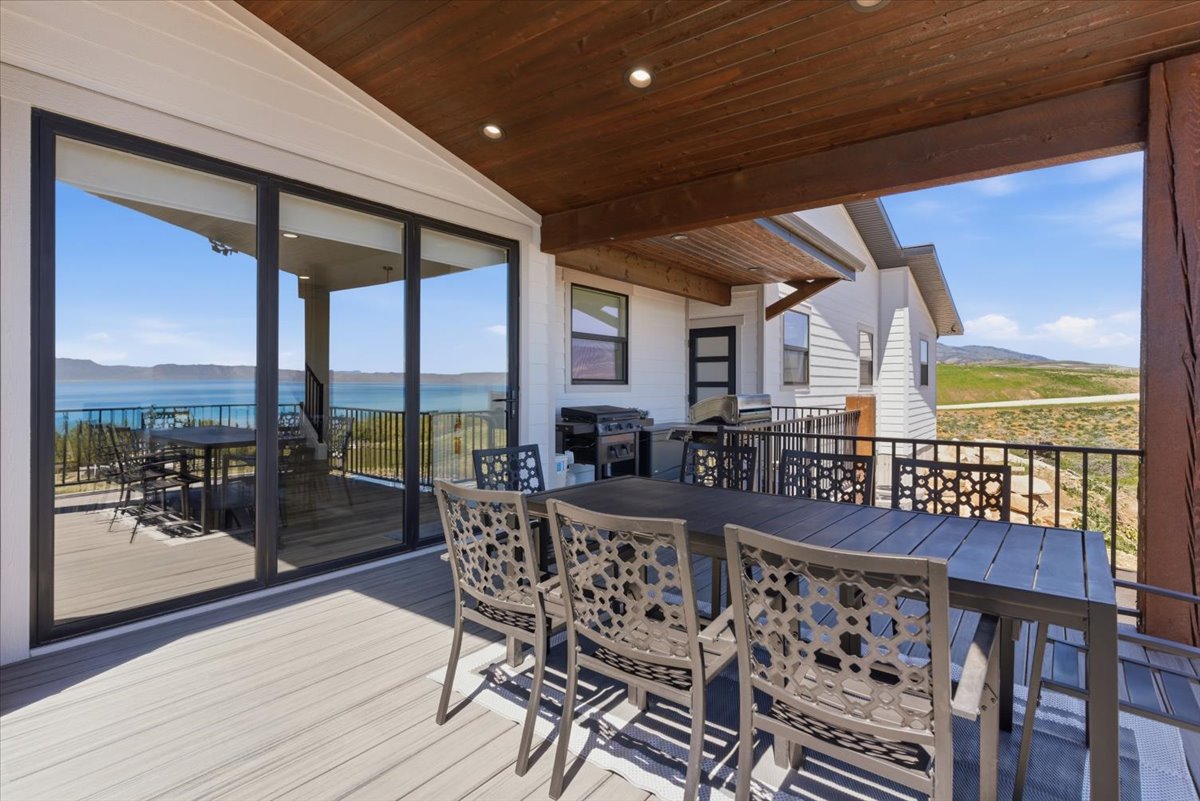 Covered outdoor deck with light wood-finish flooring
