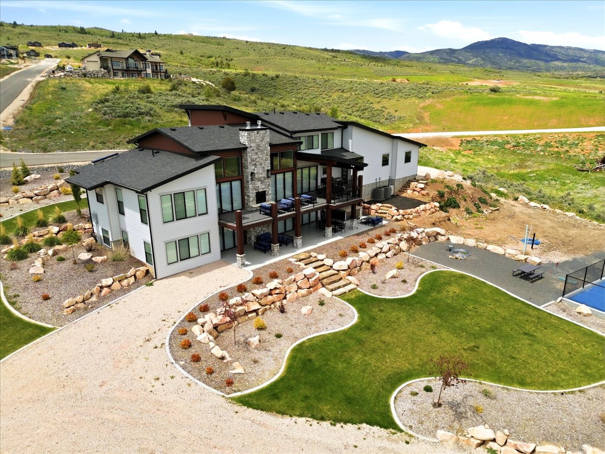 Contemporary residence featuring a multi-level design and a stone facade