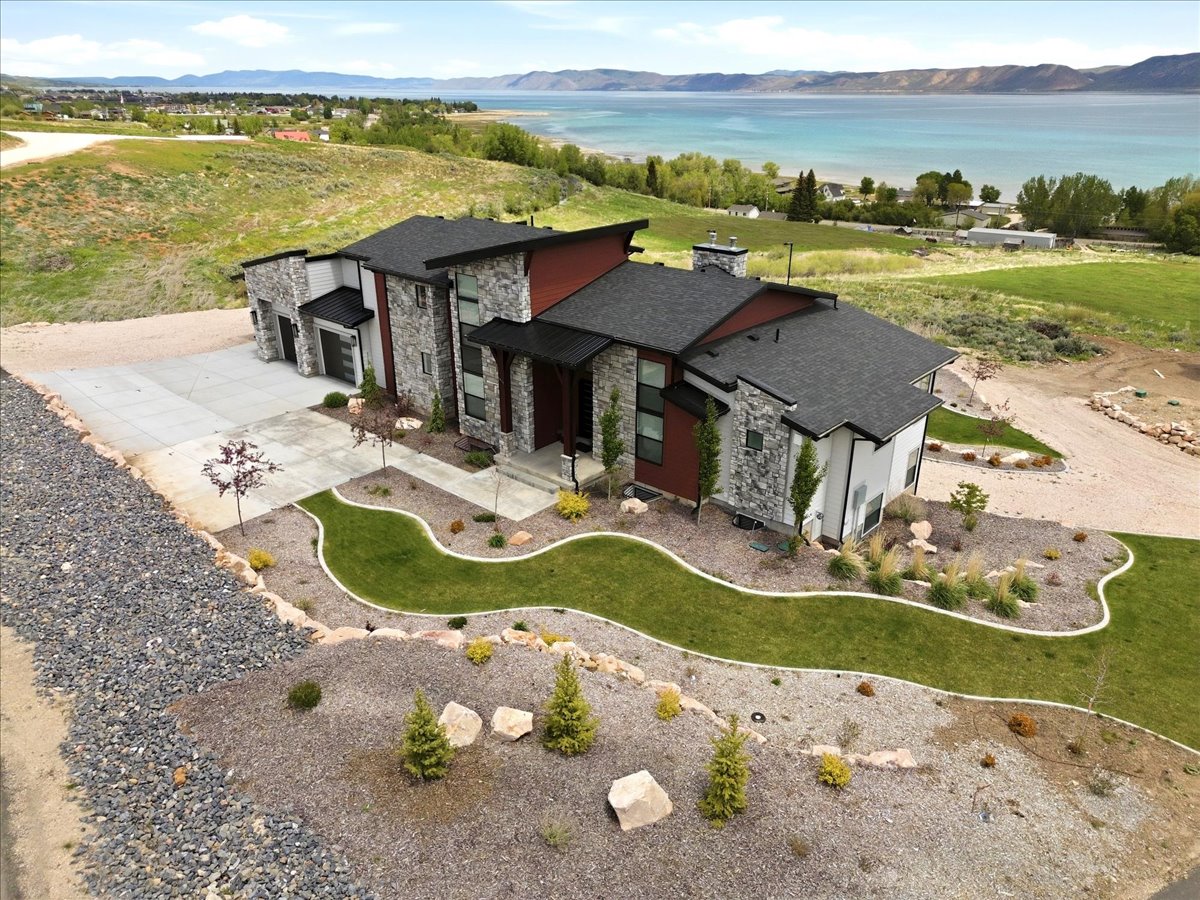 Contemporary architectural design featuring a multi-tone exterior with stone accents and dark trim