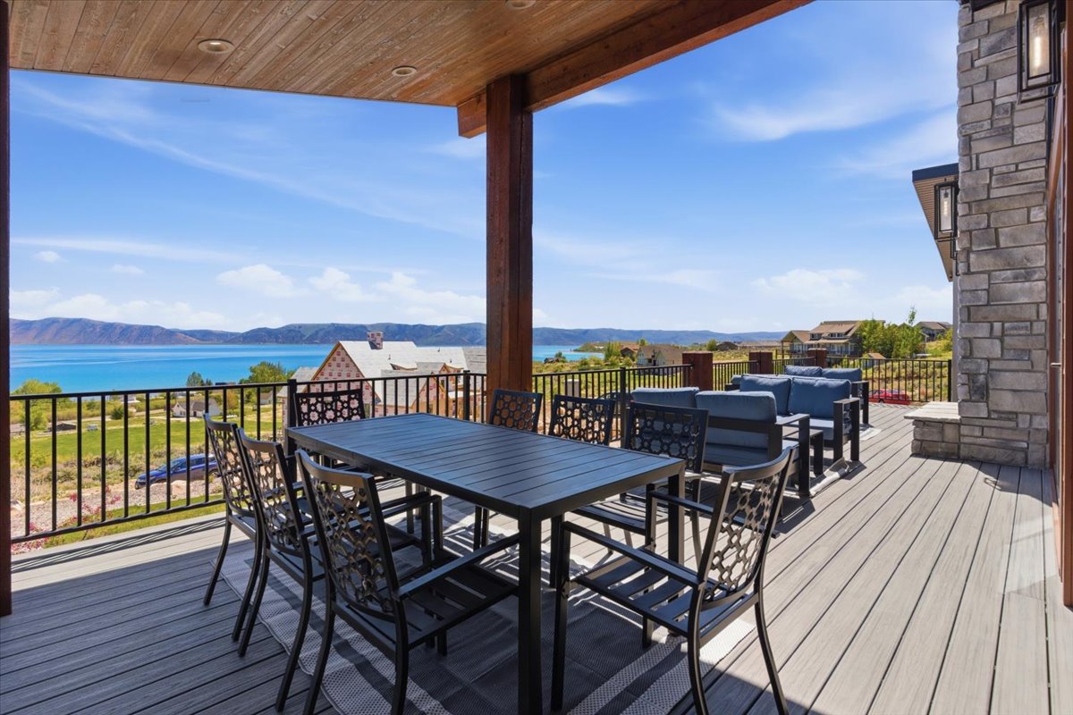 Spacious covered deck featuring composite decking and a wood-paneled ceiling