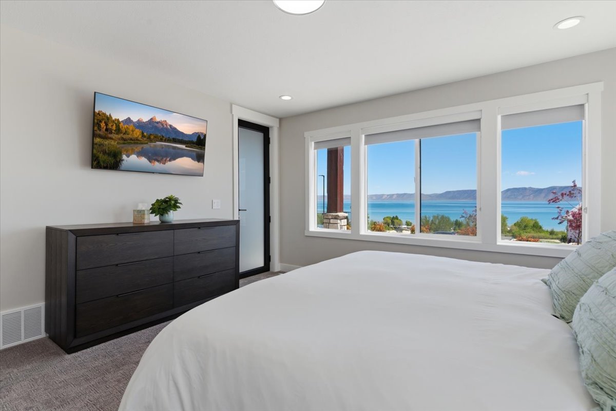 Expansive window wall overlooking the water and distant mountains