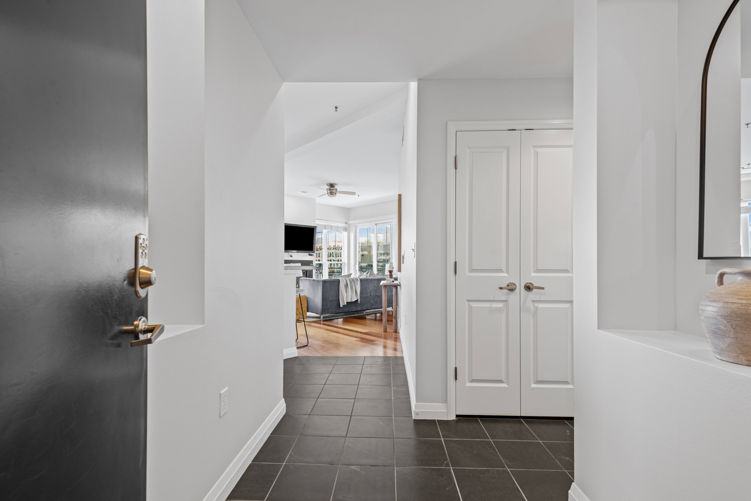 Entryway featuring dark square tile flooring