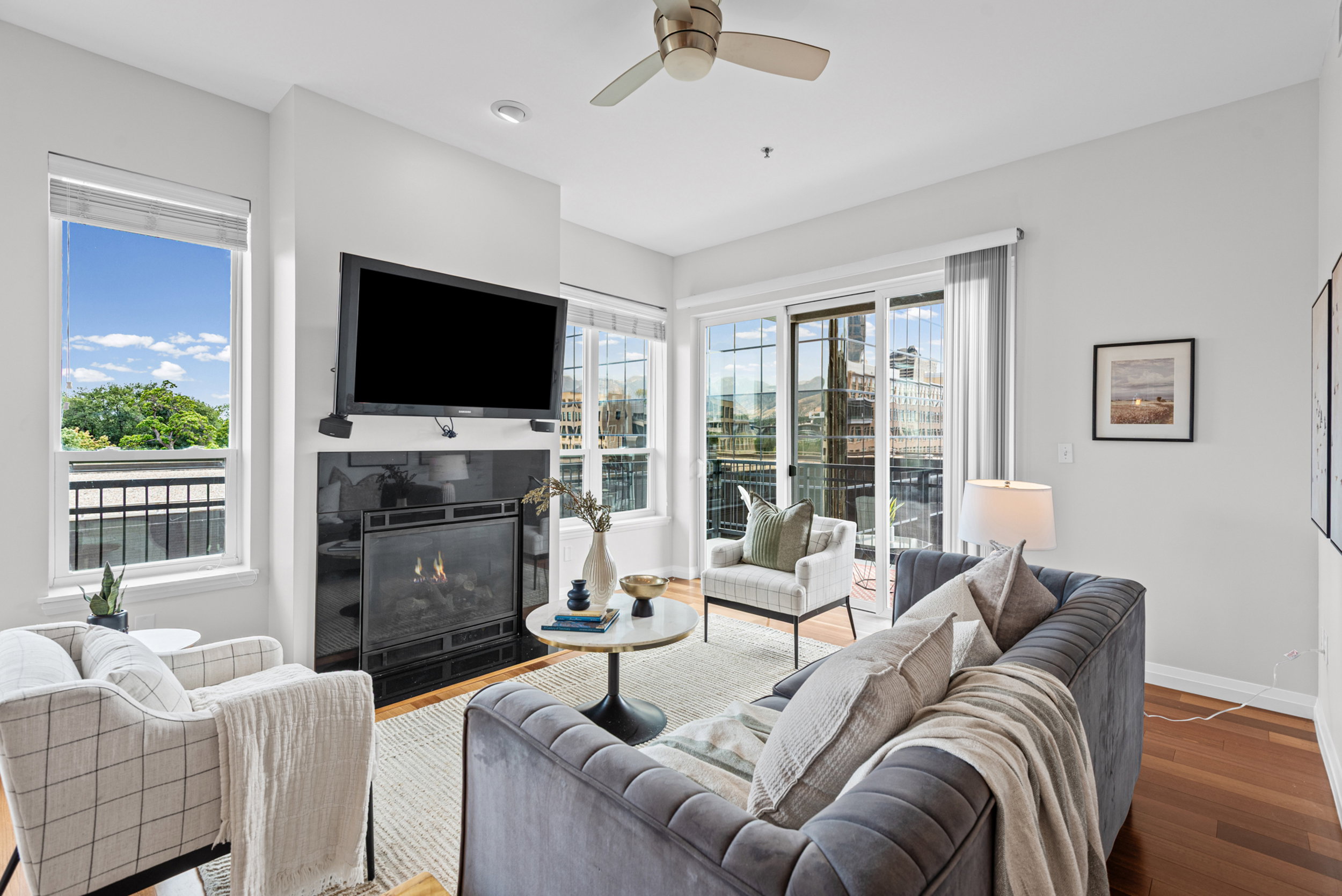 Living area featuring a black stone fireplace with a mantel, recessed lighting, and a ceiling fan