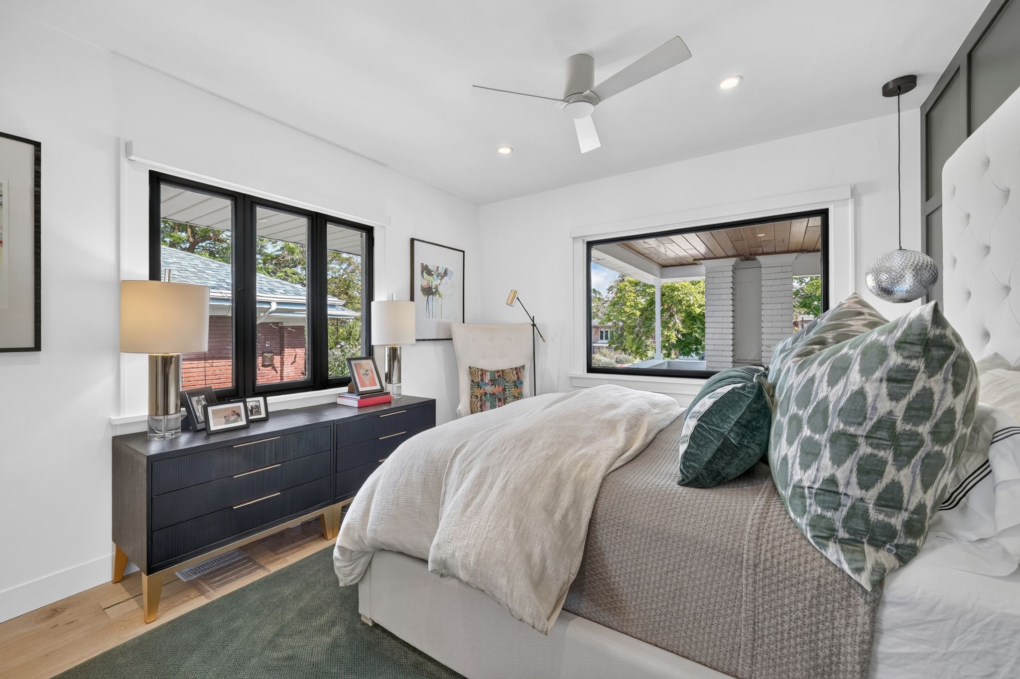 Bright bedroom with recessed lighting, a contemporary ceiling fan, and wood-finish flooring