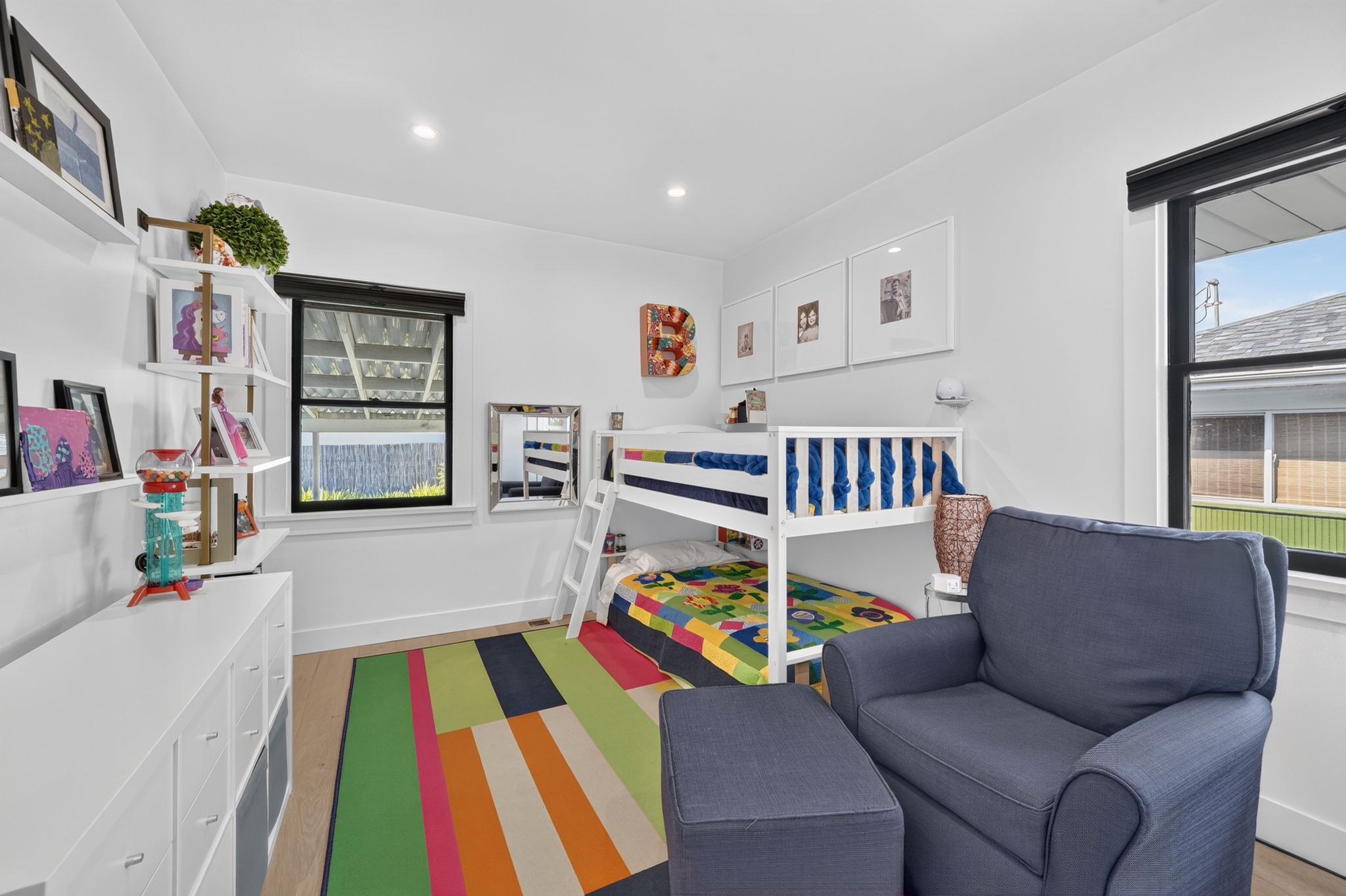 Bright room featuring light wood-finish flooring, white walls, and recessed lighting