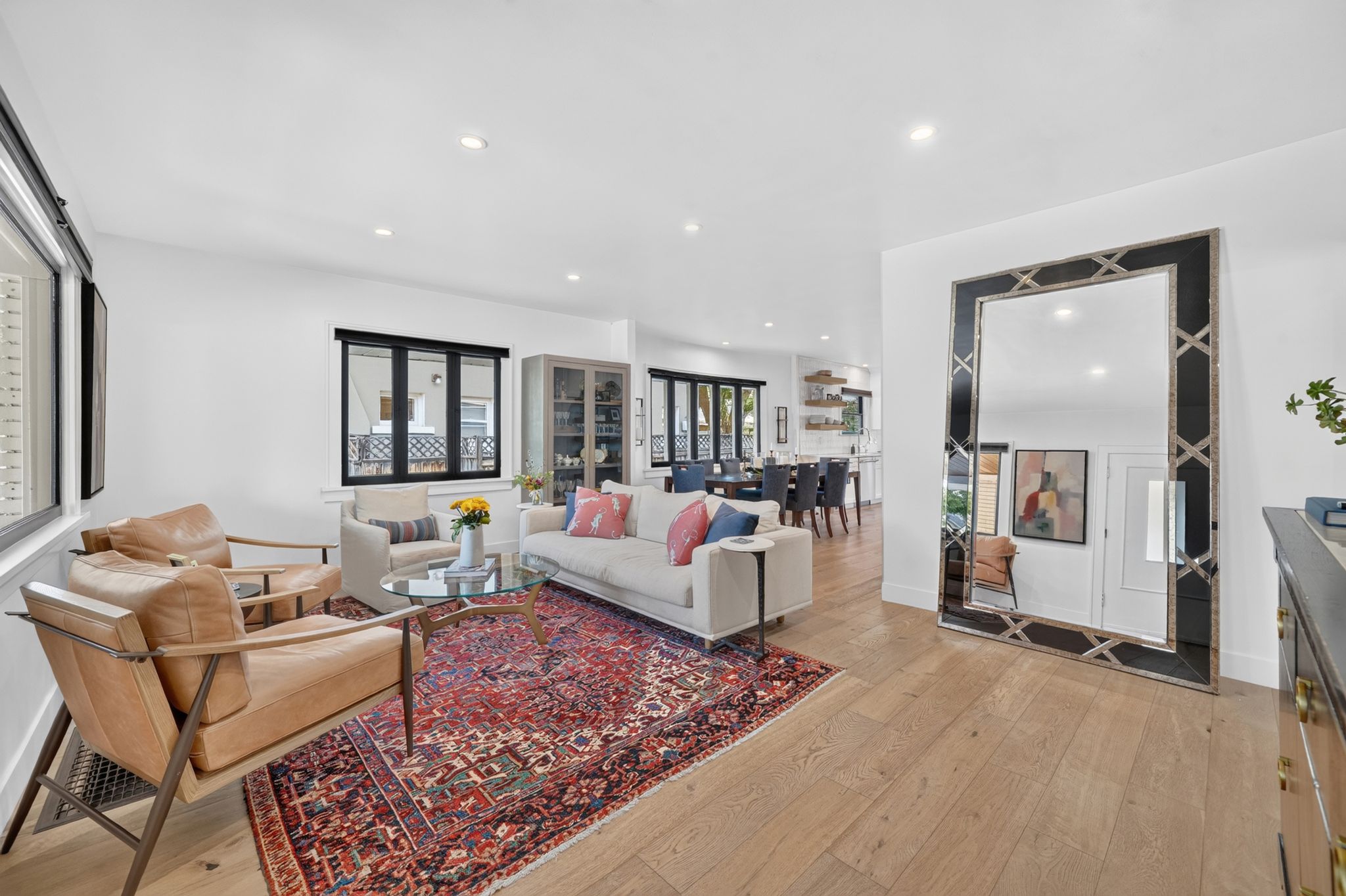 Spacious living area featuring light wood-finish flooring and recessed lighting