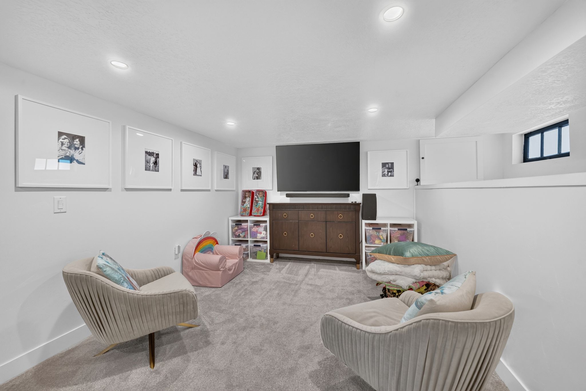 Carpeted recreation room with recessed lighting and a built-in storage unit