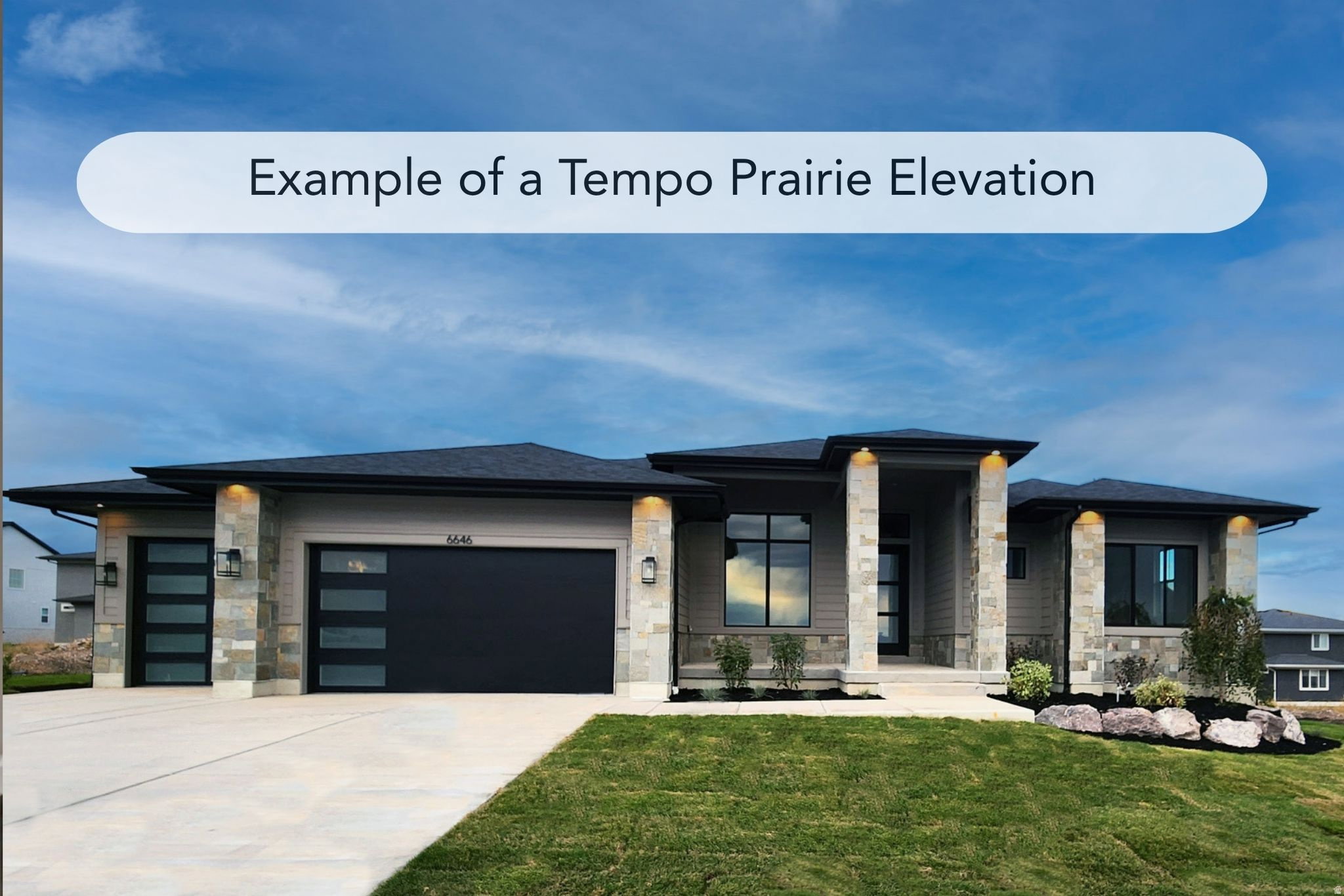 Modern prairie-style residence featuring a stone and siding exterior, multi-pane windows, and a prominent covered entry