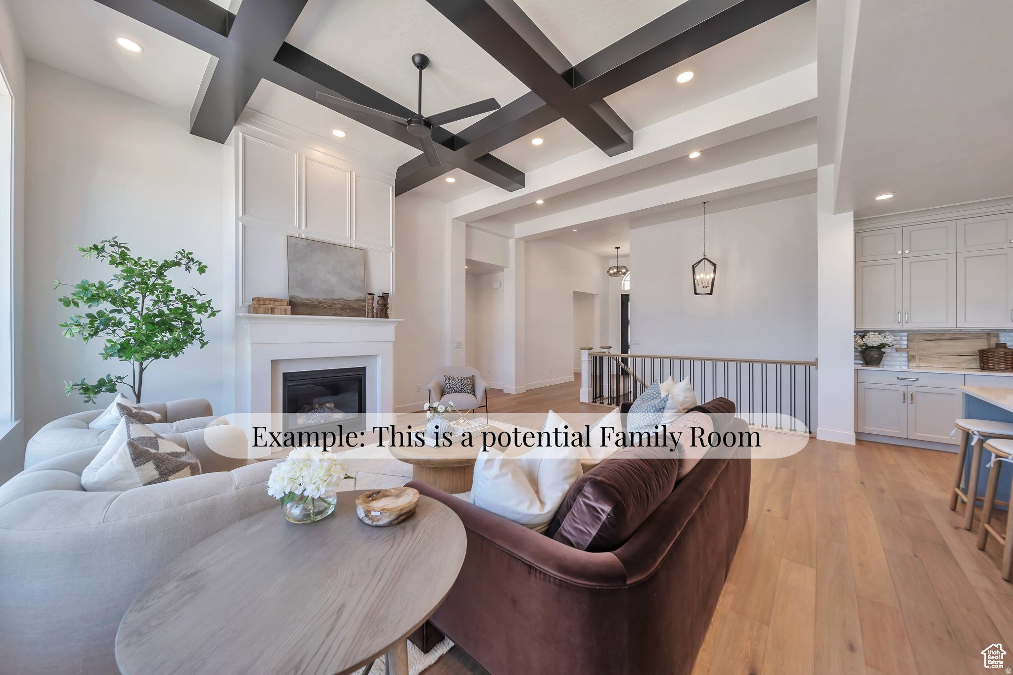 Living area featuring a fireplace with white mantel, coffered ceiling with dark wood beams, and recessed lighting