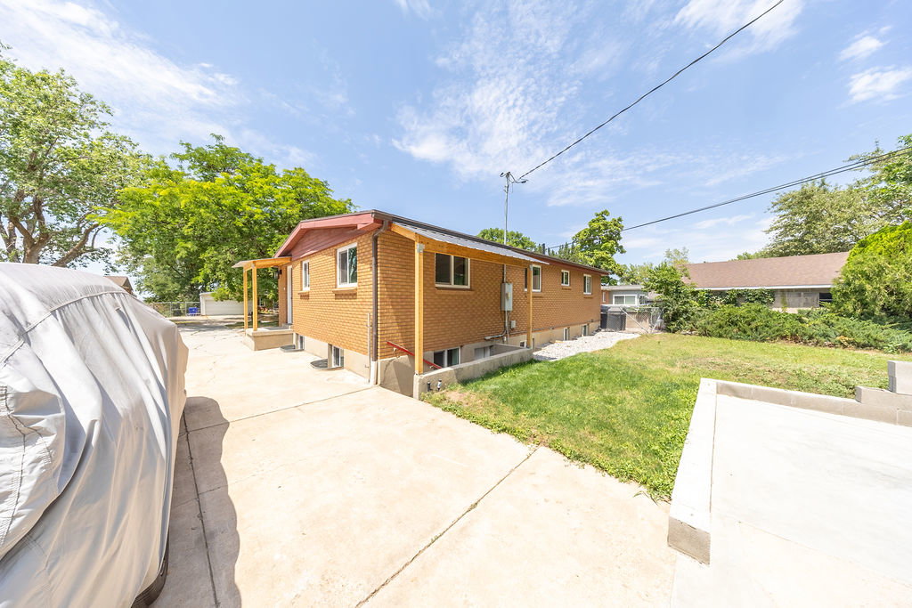 Brick exterior with a covered porch entry and a concrete driveway