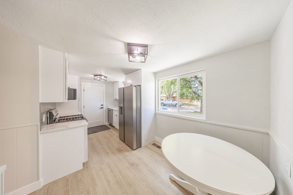 Bright kitchen space featuring light wood-finish flooring