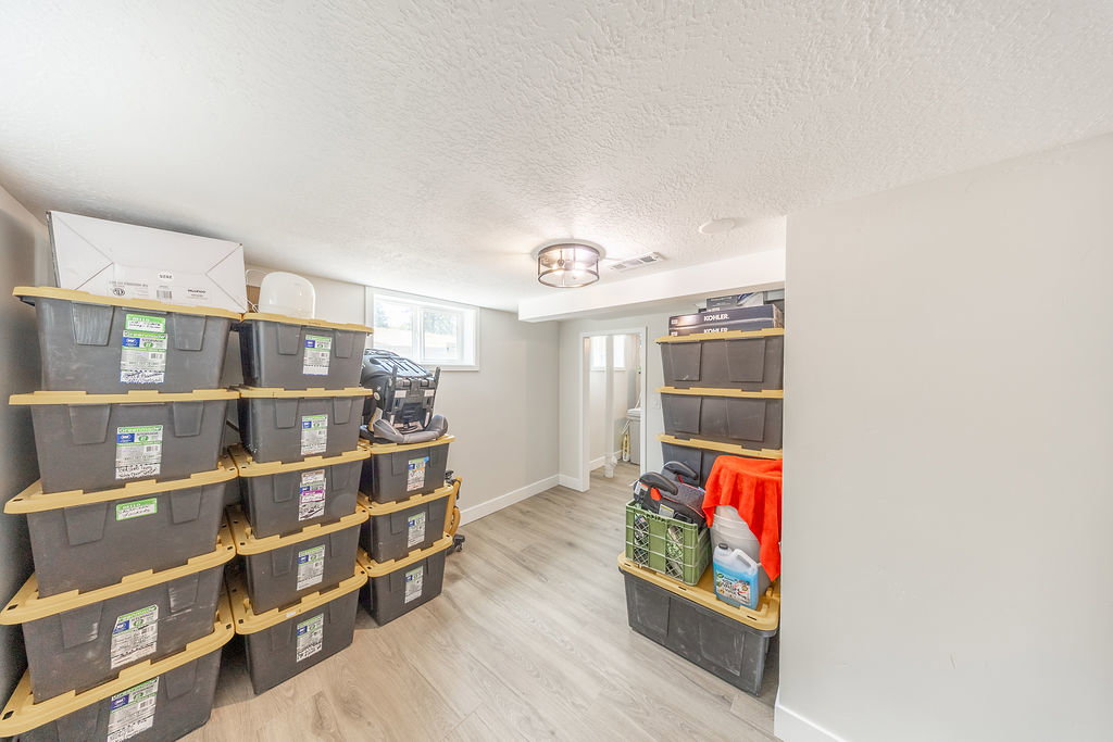 Finished room with light wood-finish flooring, recessed lighting, and a window providing natural light