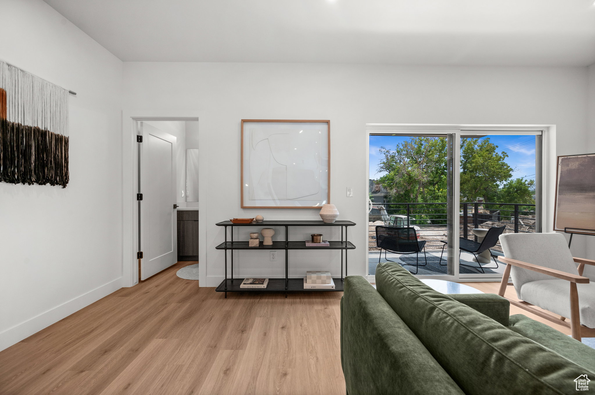 Hardwood-finish flooring extending to a sliding glass door balcony