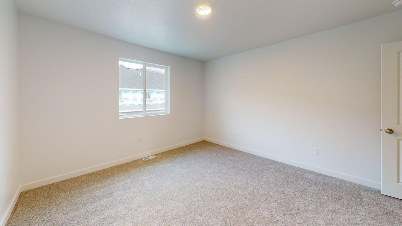 Neutral-toned carpeting spans the room, complemented by white walls and trim