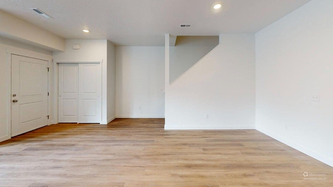 Open-concept room featuring wood-finish flooring, white walls, and recessed lighting