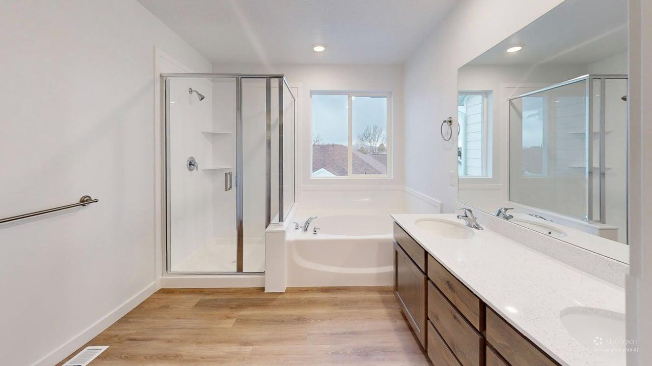 Contemporary bathroom featuring a dual vanity with light-colored countertops, a built-in tub, a separate glass-enclosed shower, and wood-finish flooring