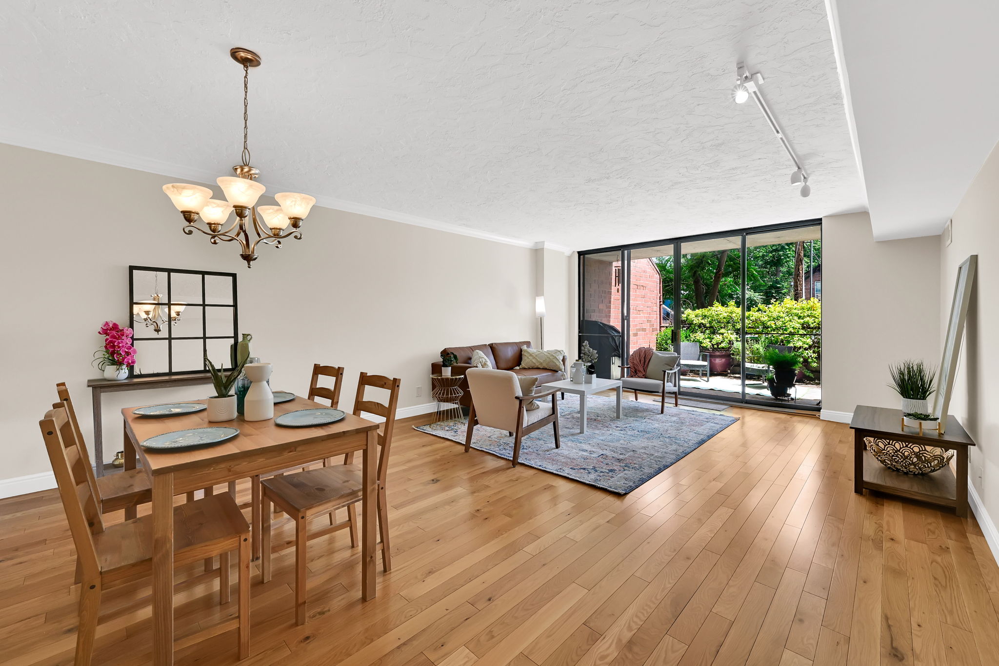 Open concept living area featuring wood-finish flooring