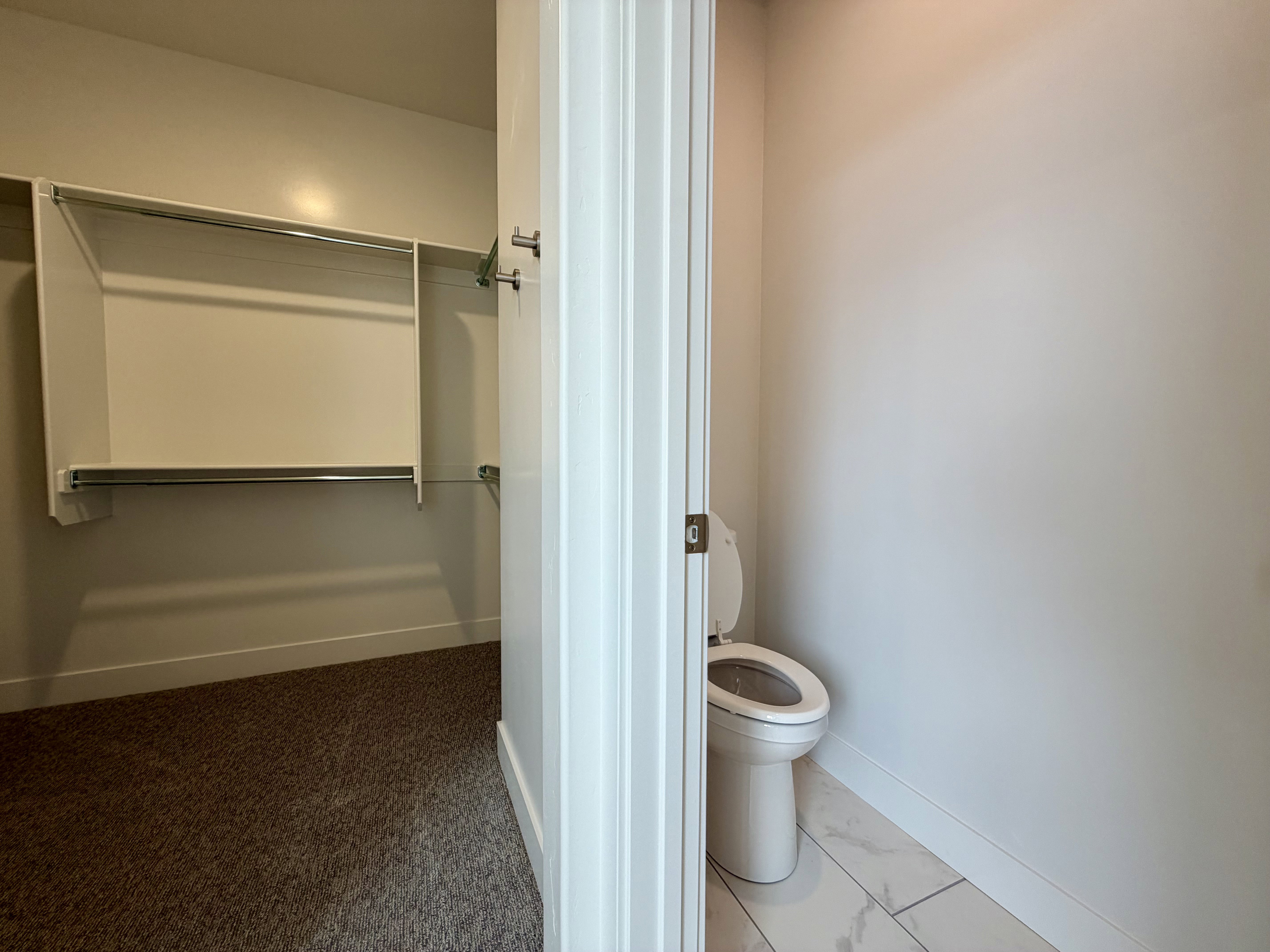 Walk-in closet with integrated shelving and hanging rods