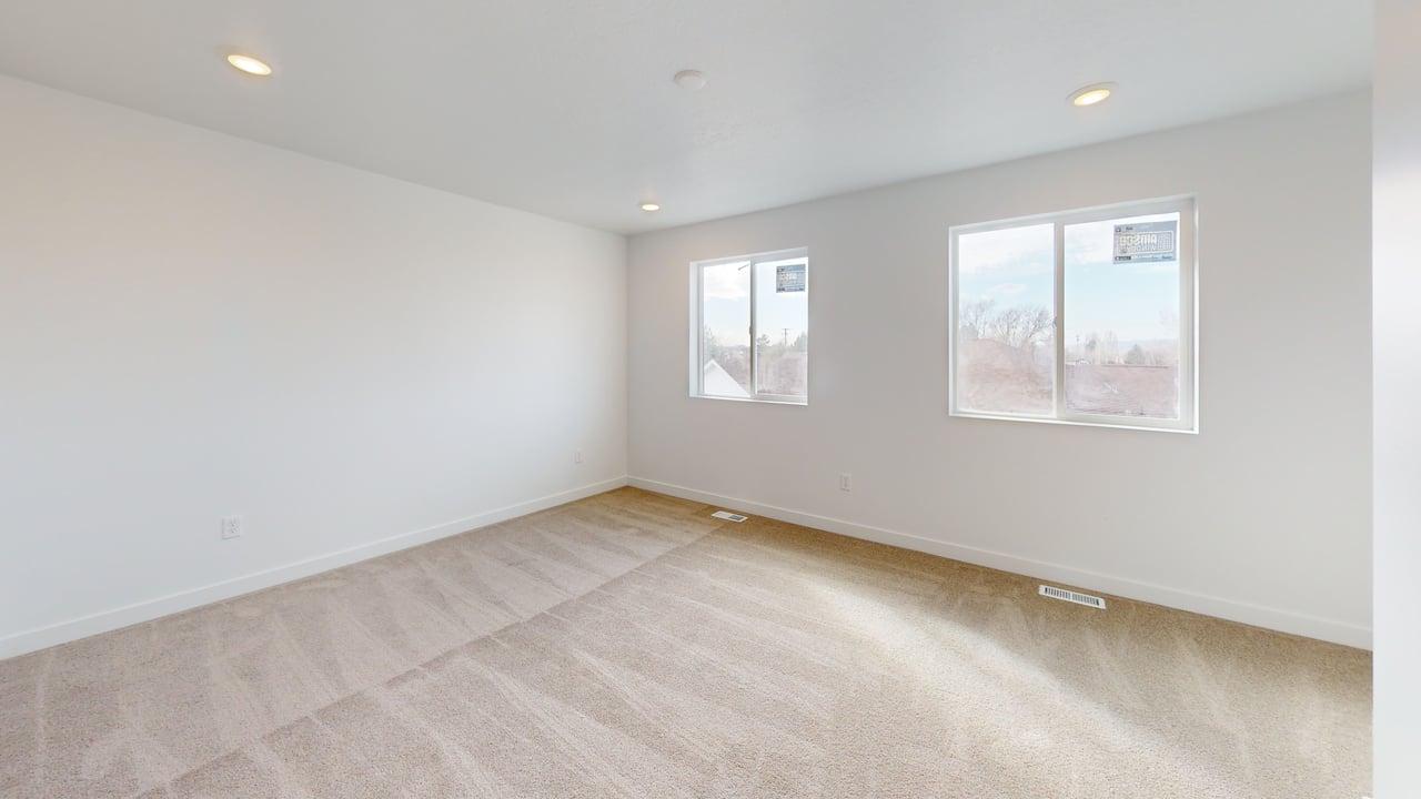 Spacious room with plush carpet flooring and recessed ceiling lighting