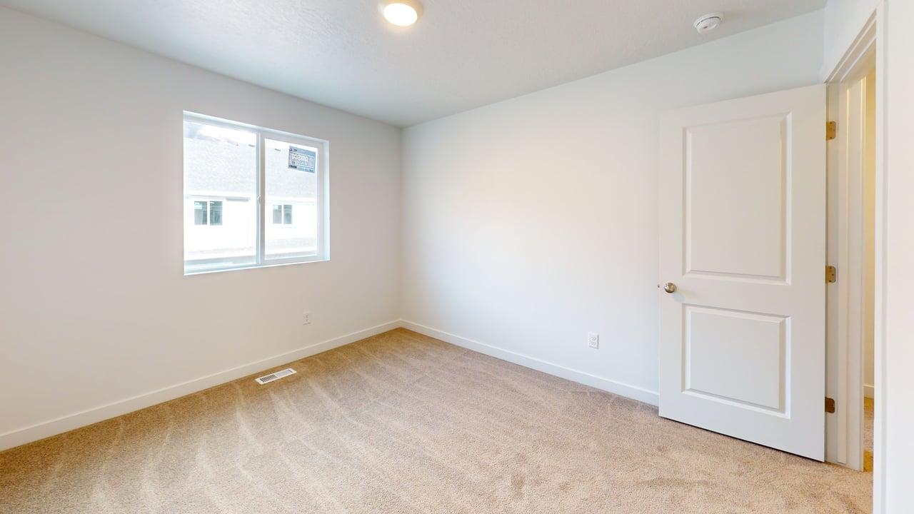 Room featuring neutral tone carpeting and white walls