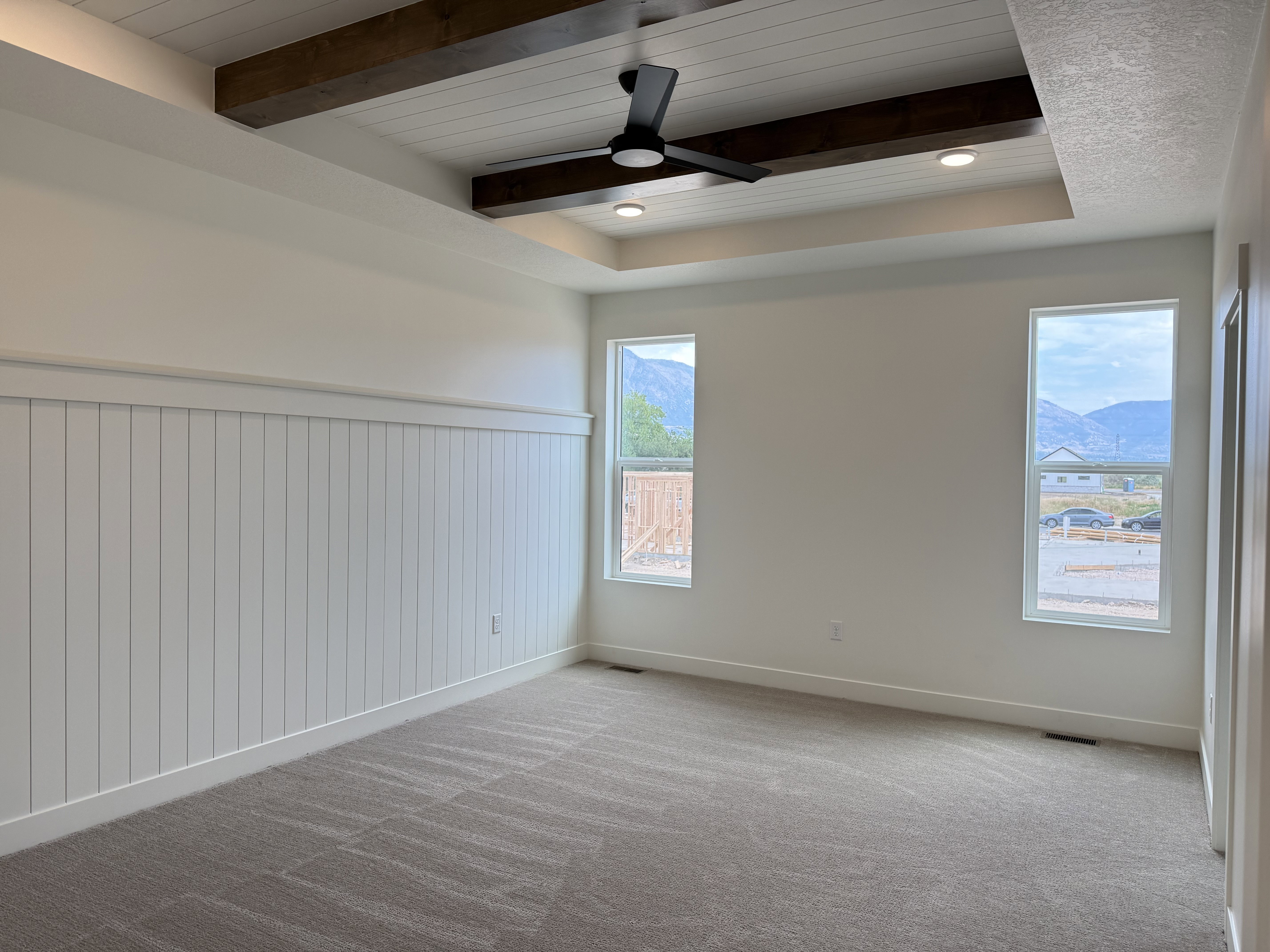 Recessed tray ceiling with wood beams and shiplap detailing