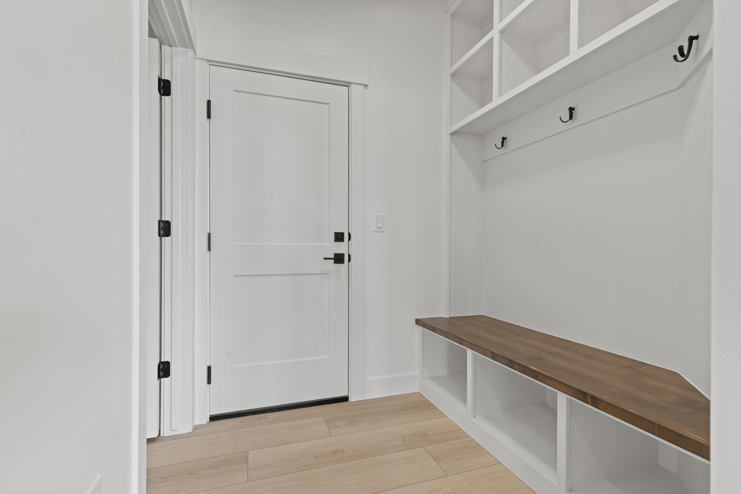 Built-in mudroom bench with a wood-finish top and integrated storage cubbies