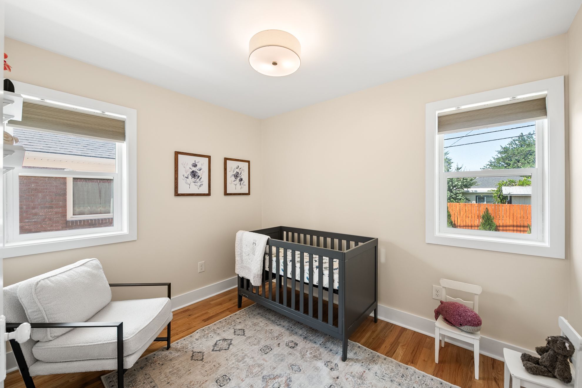 Bright room featuring light-colored walls and wood-finish flooring