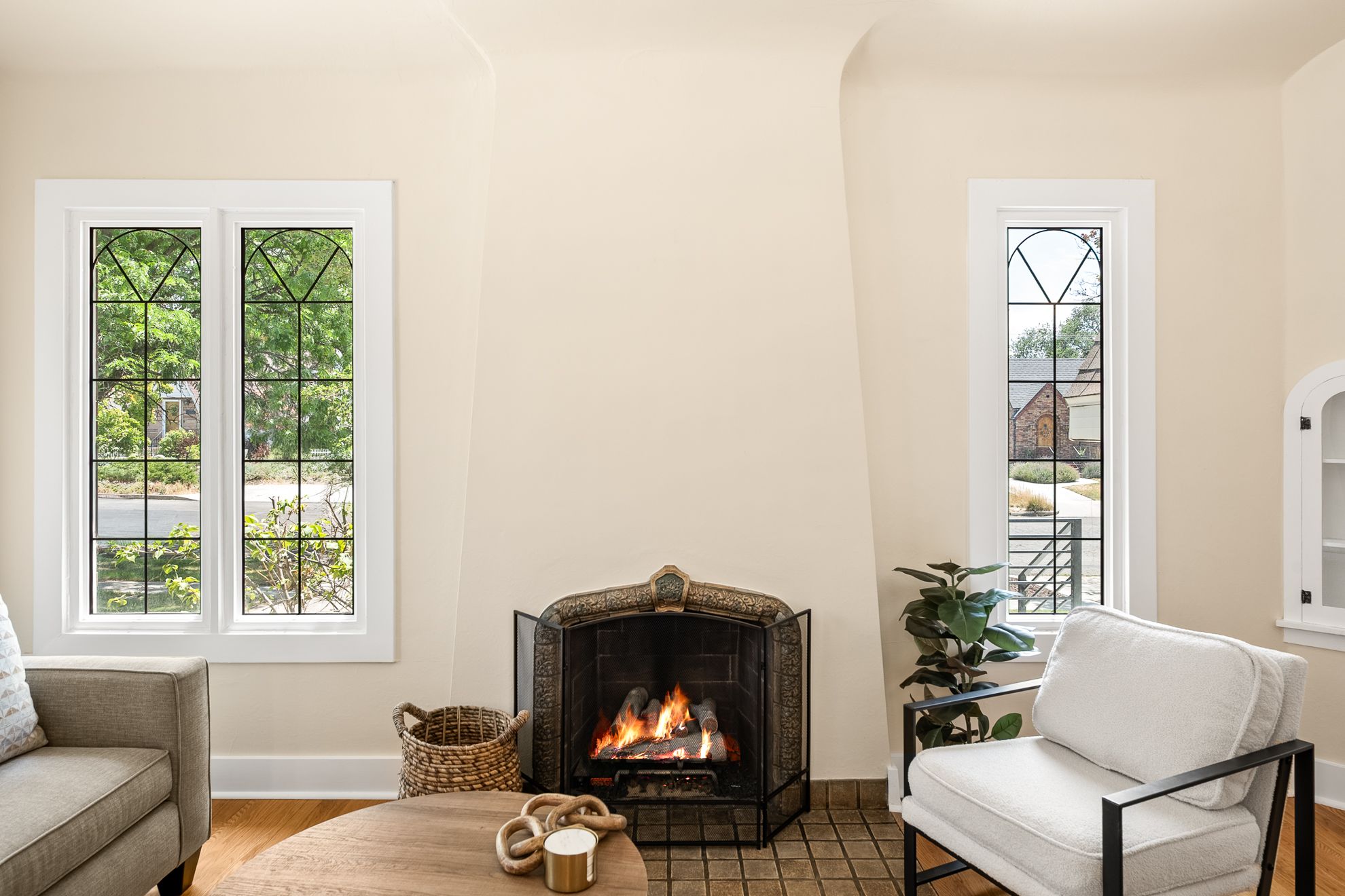 Living area featuring a prominent fireplace with a decorative screen and a tile hearth