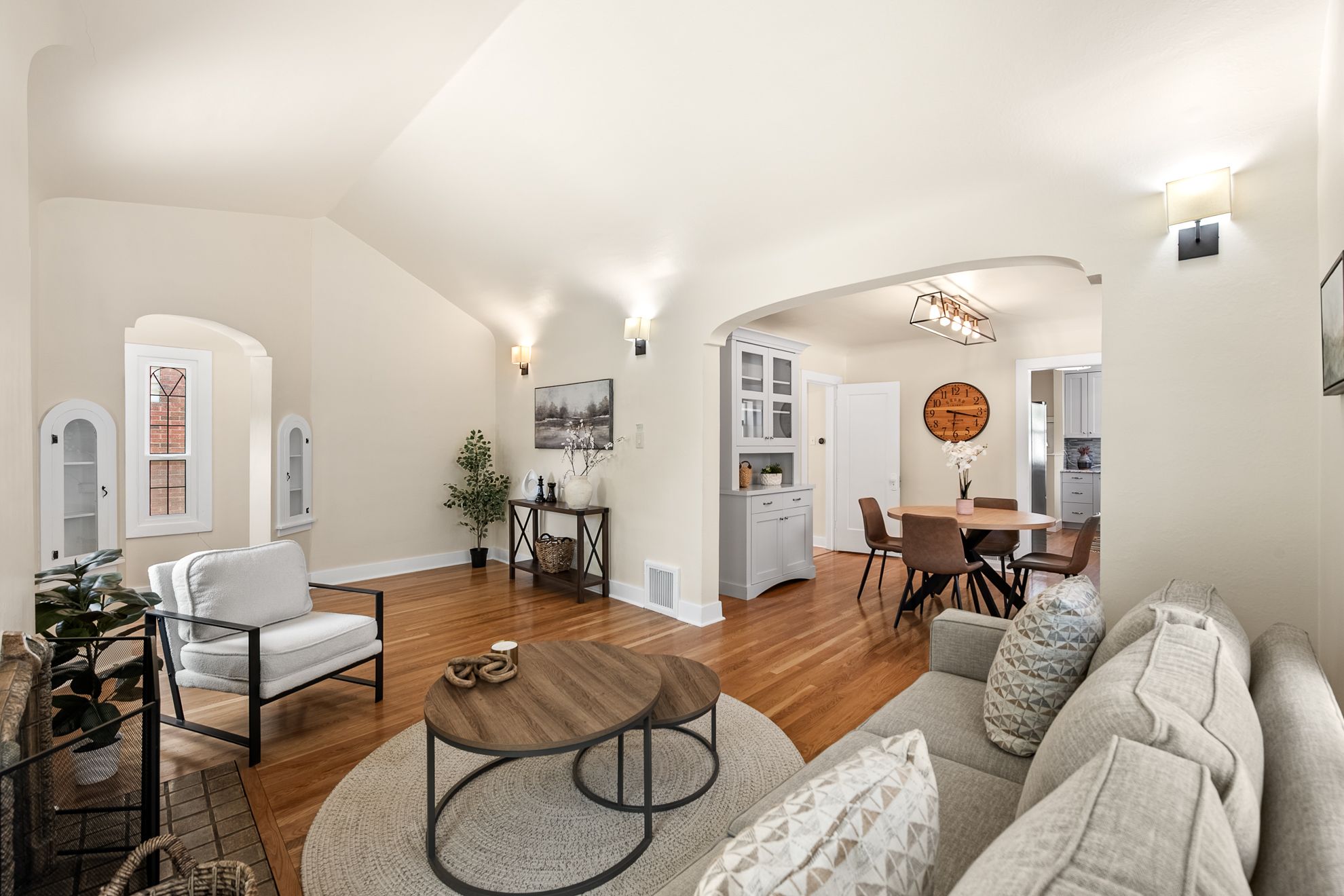 Bright living area with hardwood flooring and vaulted ceilings
