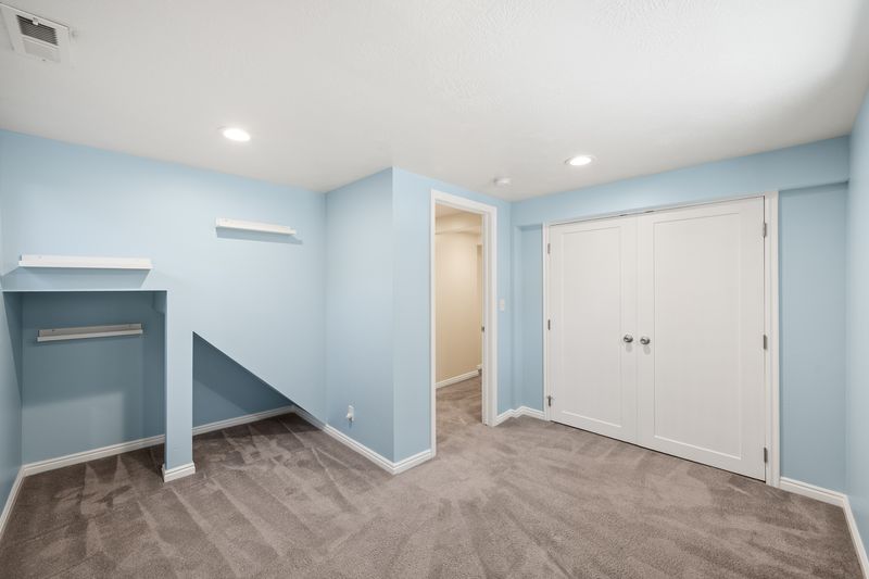 Room featuring light blue walls, gray carpet, and white baseboards