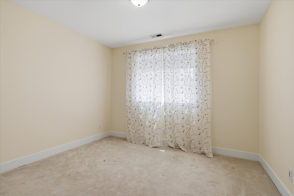 Neutral-toned walls complement the light-colored carpeting