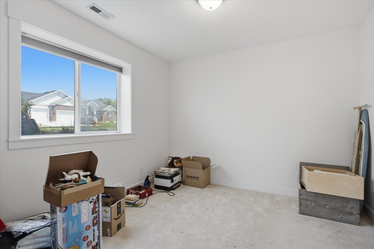 Neutral wall finishes and light carpeting create a versatile interior space