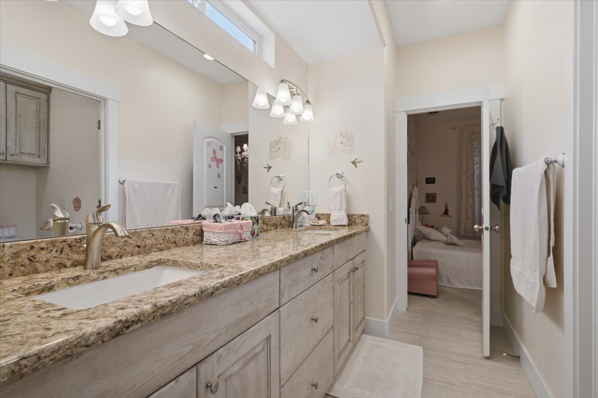 Dual vanity with stone countertop, undermount sinks, and brushed nickel fixtures
