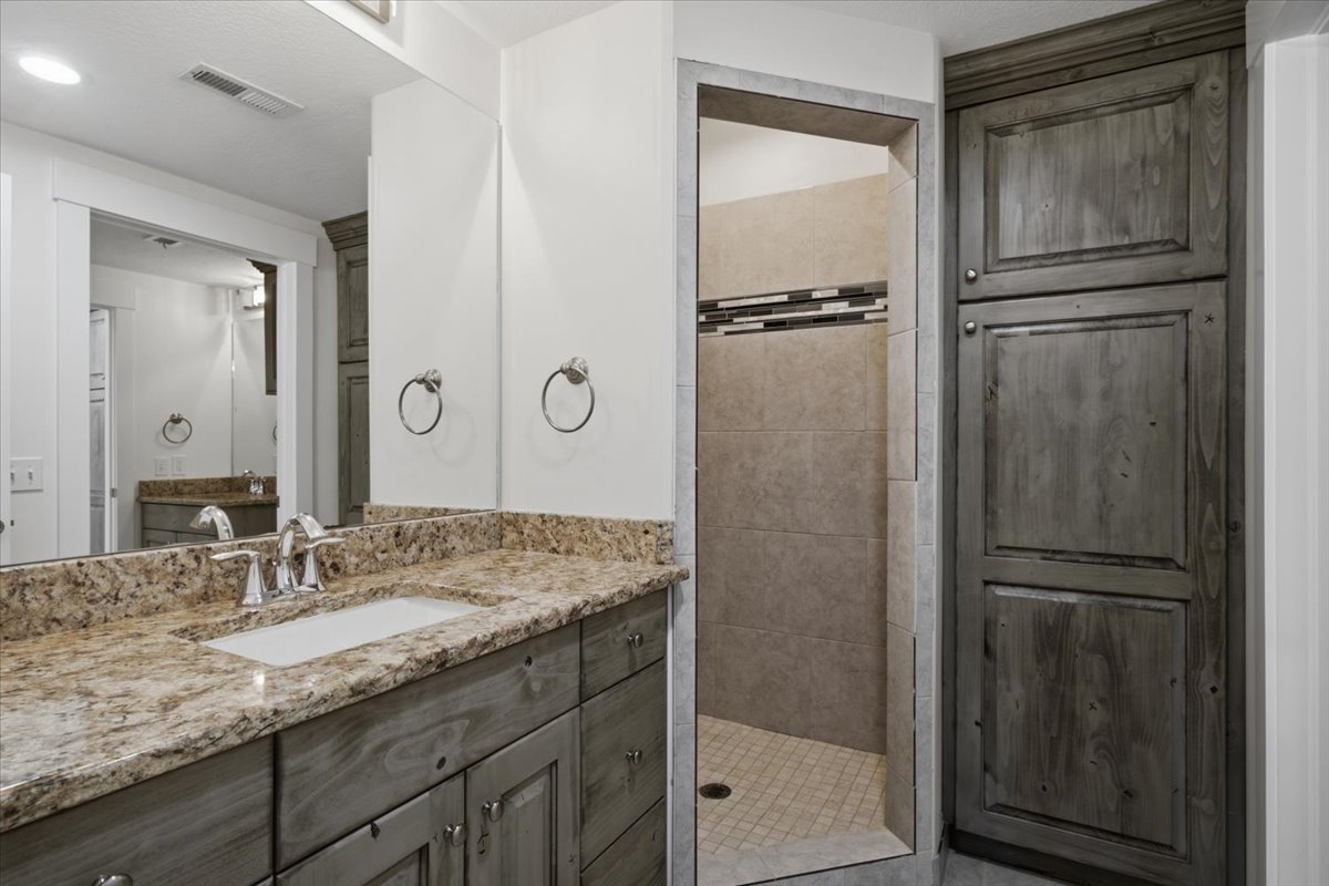 Double vanity with a granite countertop and an undermount sink