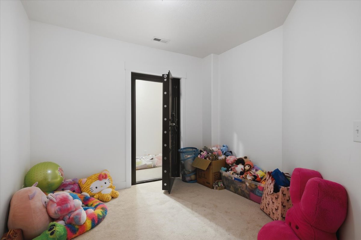Interior space with carpeted flooring and white painted walls