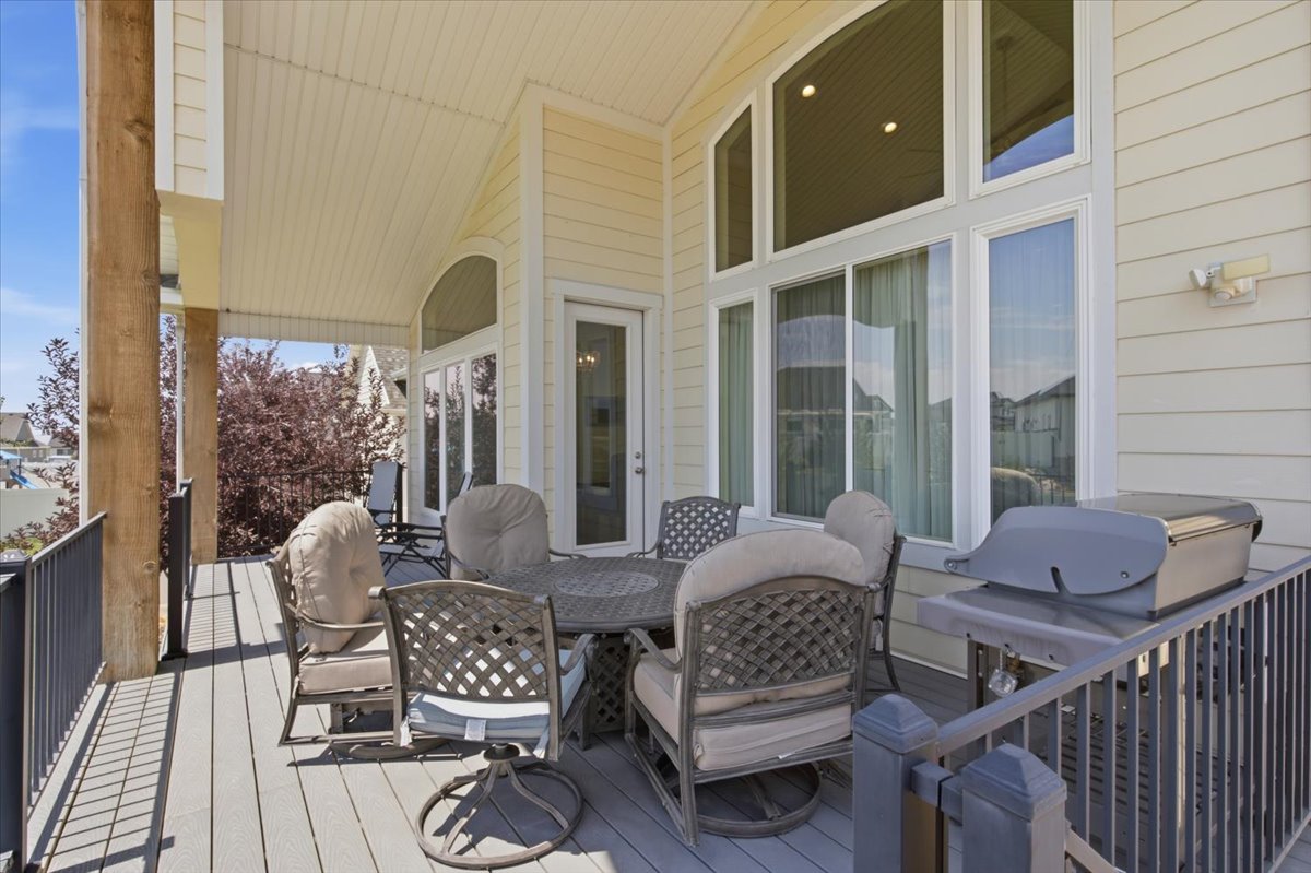 Covered outdoor deck featuring composite decking and a vaulted ceiling