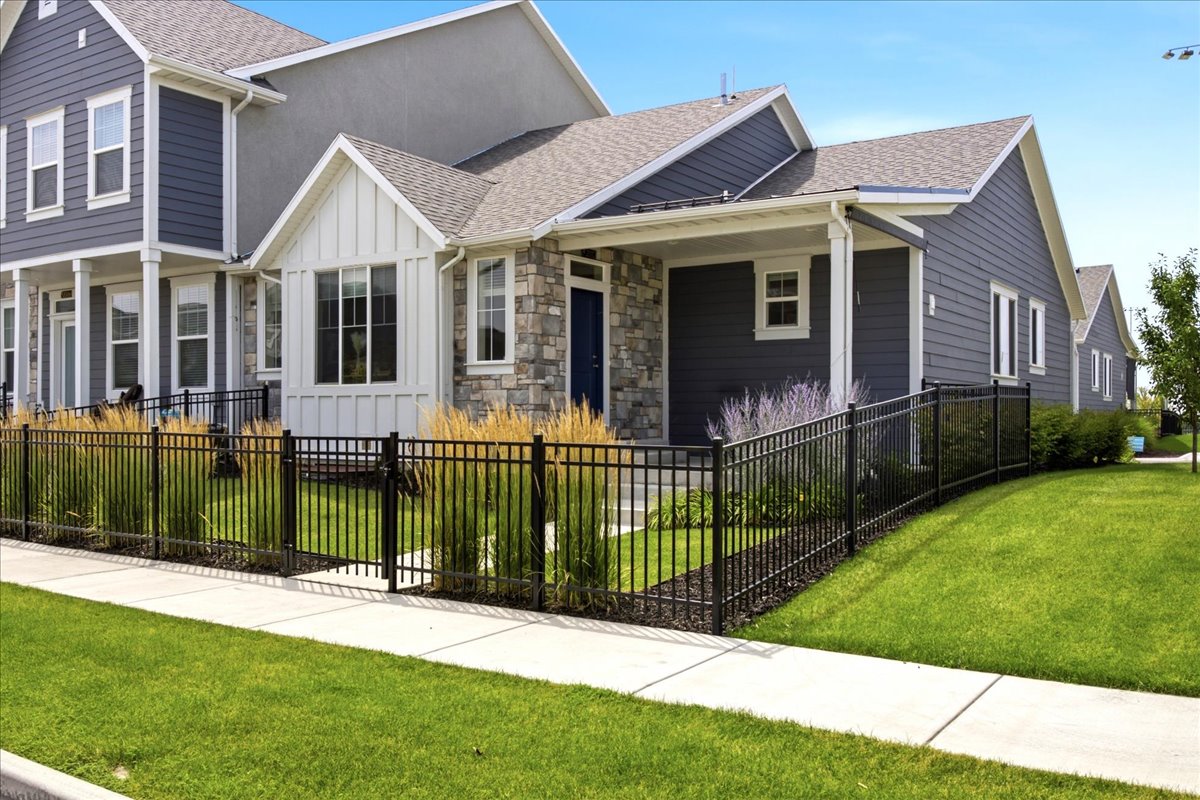 Modern exterior featuring horizontal siding, stone veneer, and white trim accents