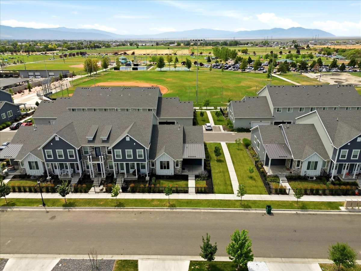 Modern townhome community featuring varied facade treatments, pitched shingle roofs, and distinct covered entryways